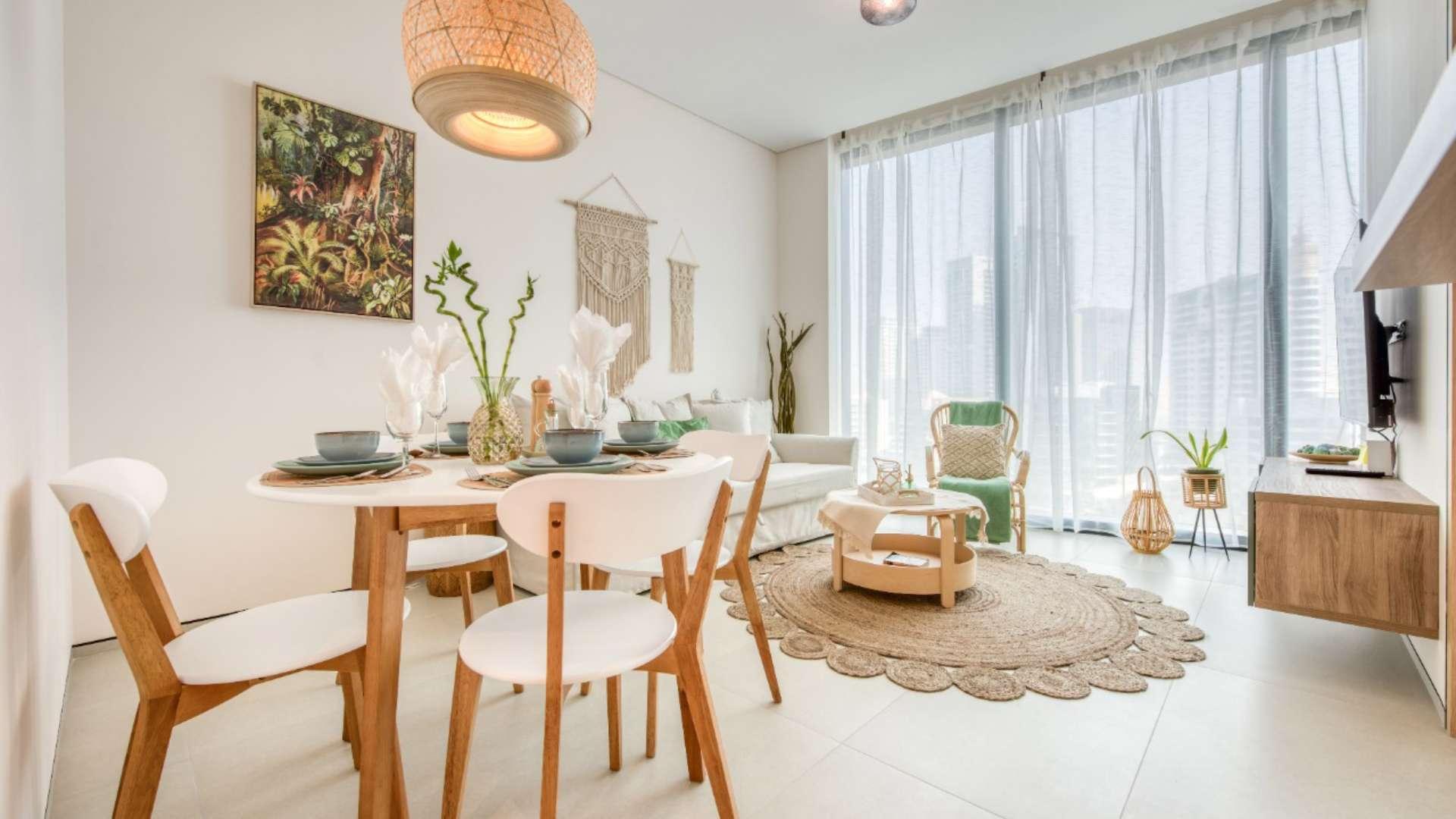 Fully furnished living area with dining table in Jumeirah Beach Residence apartment