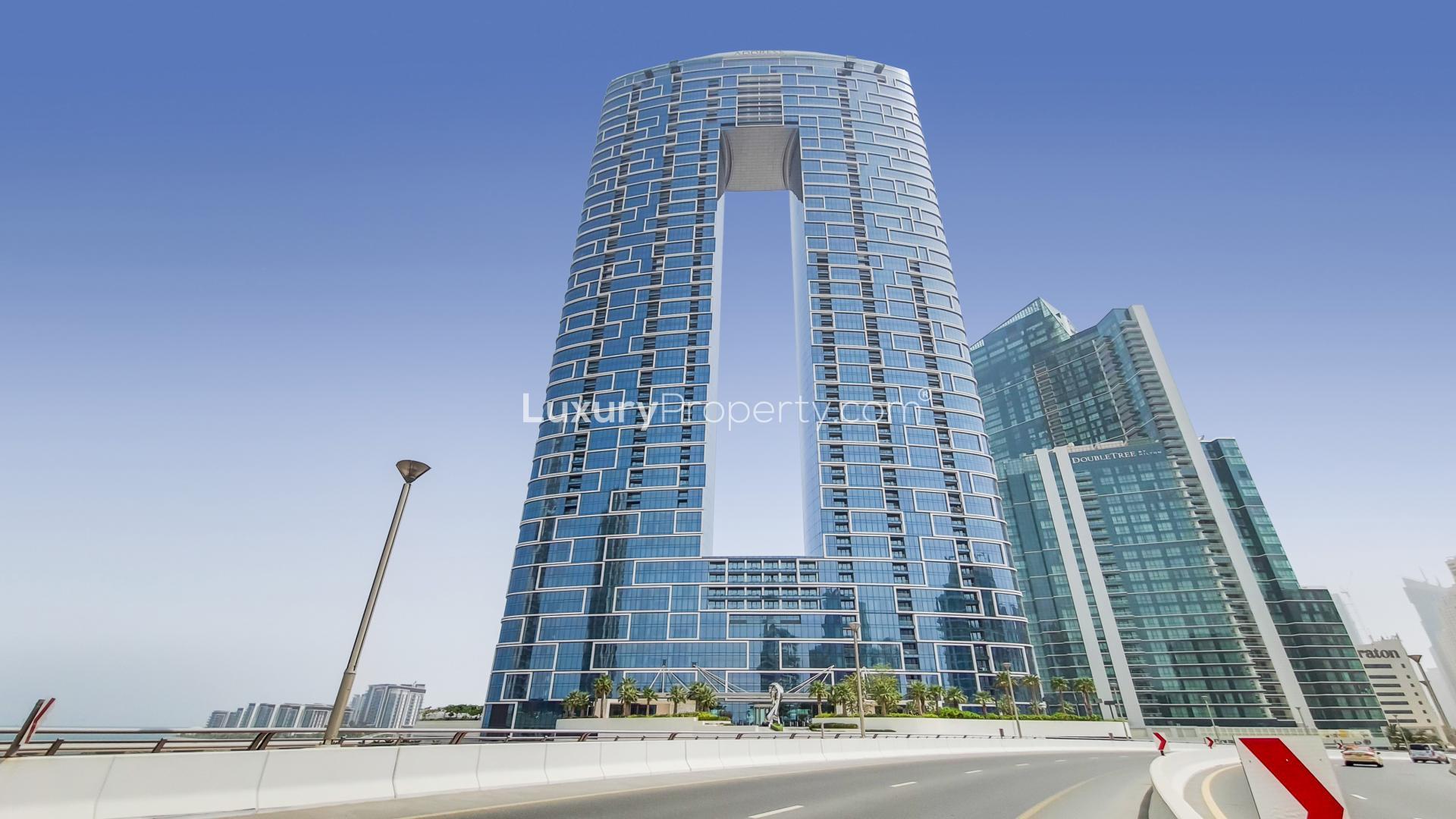 Modern living room in Jumeirah Beach Residence apartment with marina view balcony