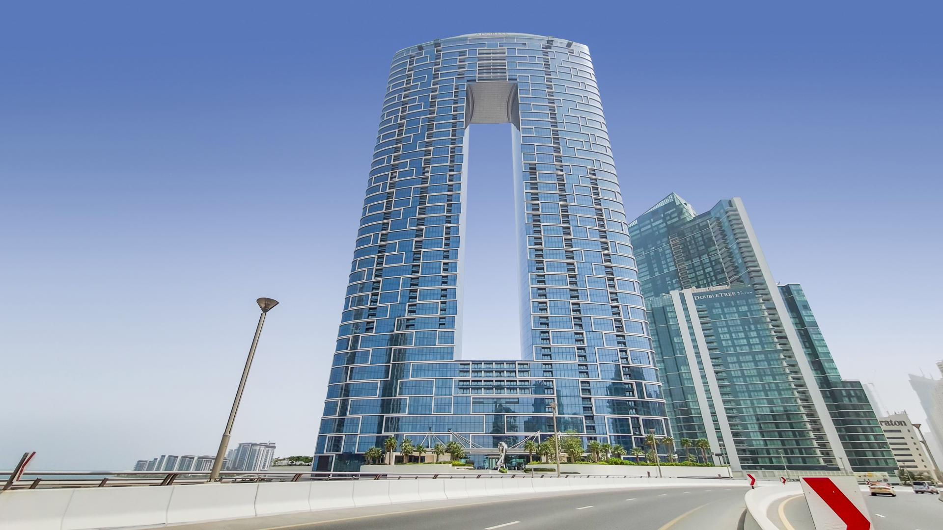 Modern living room in Jumeirah Beach Residence apartment with marina view balcony