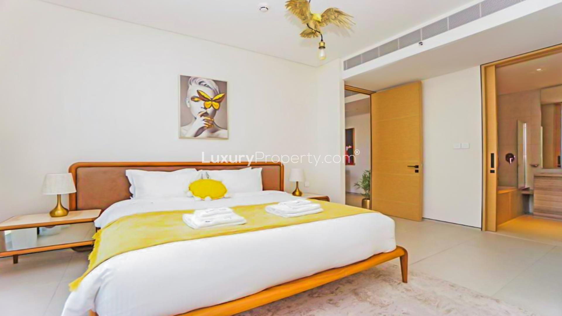 Luxurious bedroom in Jumeirah Beach Residence apartment, modern decor, ensuite bathroom, elegant design