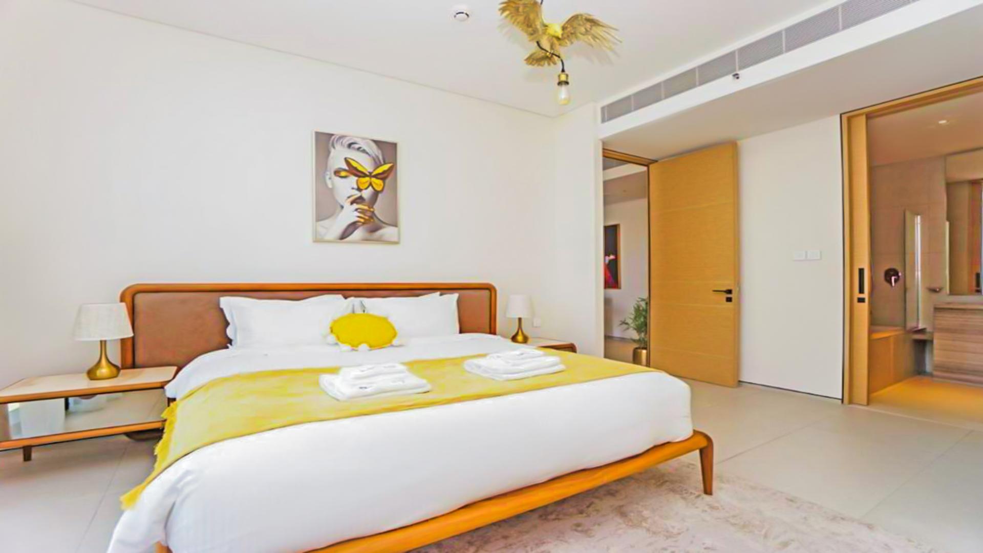 Luxurious bedroom in Jumeirah Beach Residence apartment, modern decor, ensuite bathroom, elegant design