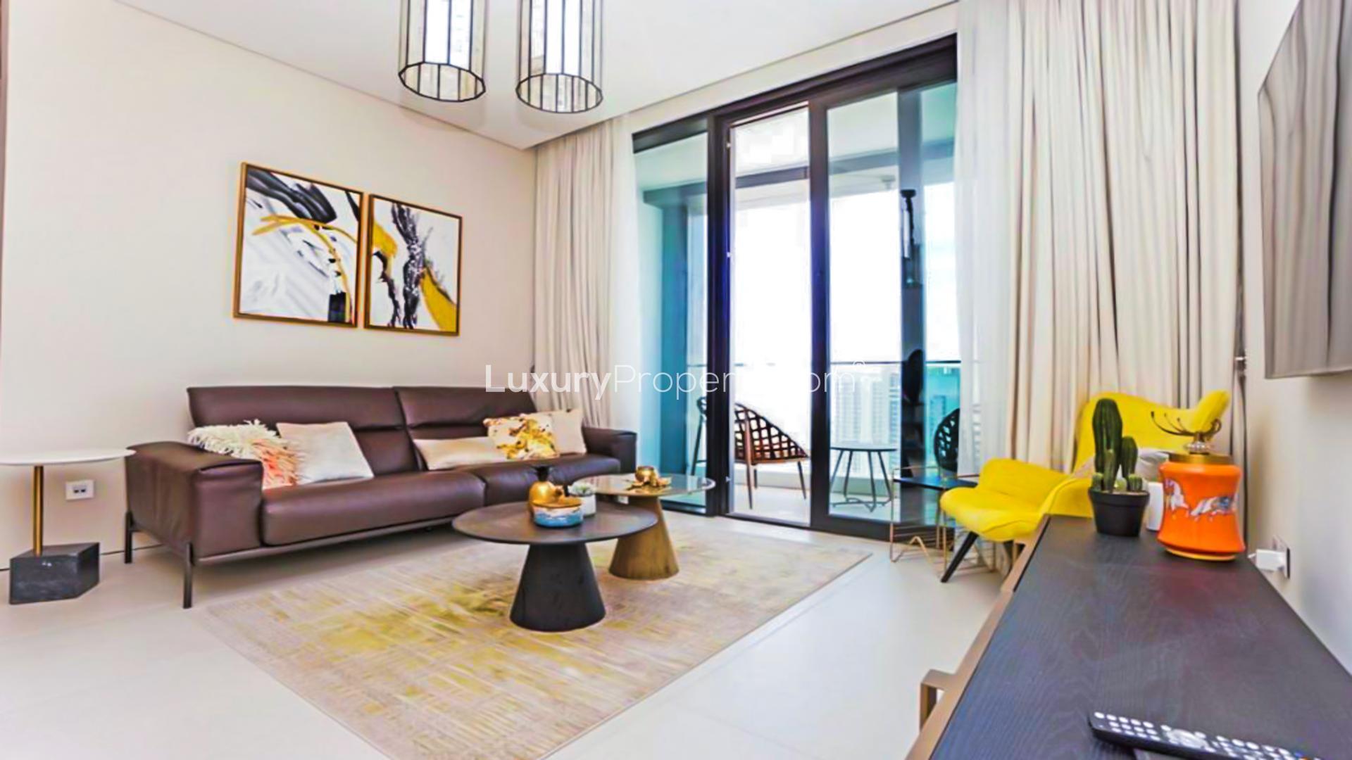 "Luxury apartment with stunning marina view in Jumeirah Beach Residence, Dubai skyline backdrop.",Luxury apartment living room with modern decor and marina views, Jumeirah Beach Residence