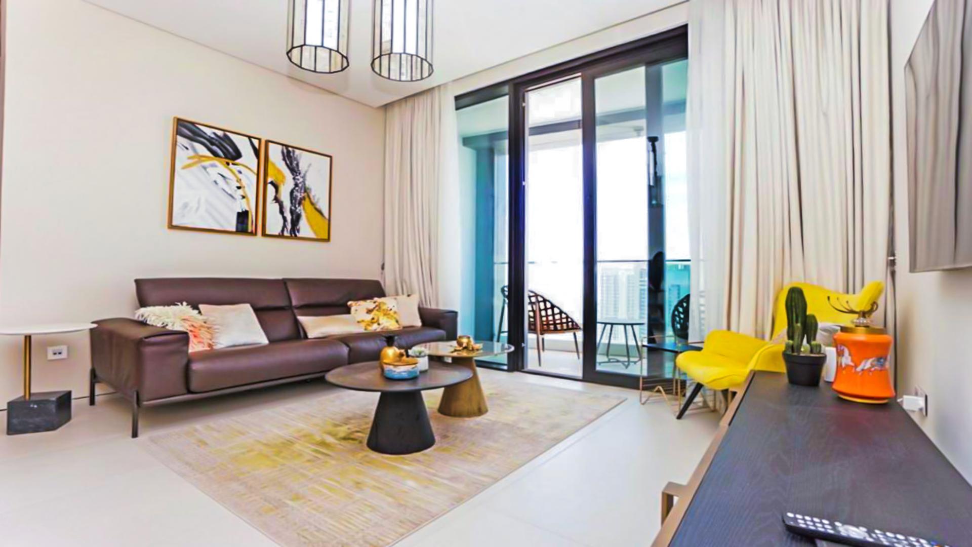 "Luxury apartment with stunning marina view in Jumeirah Beach Residence, Dubai skyline backdrop.",Luxury apartment living room with modern decor and marina views, Jumeirah Beach Residence