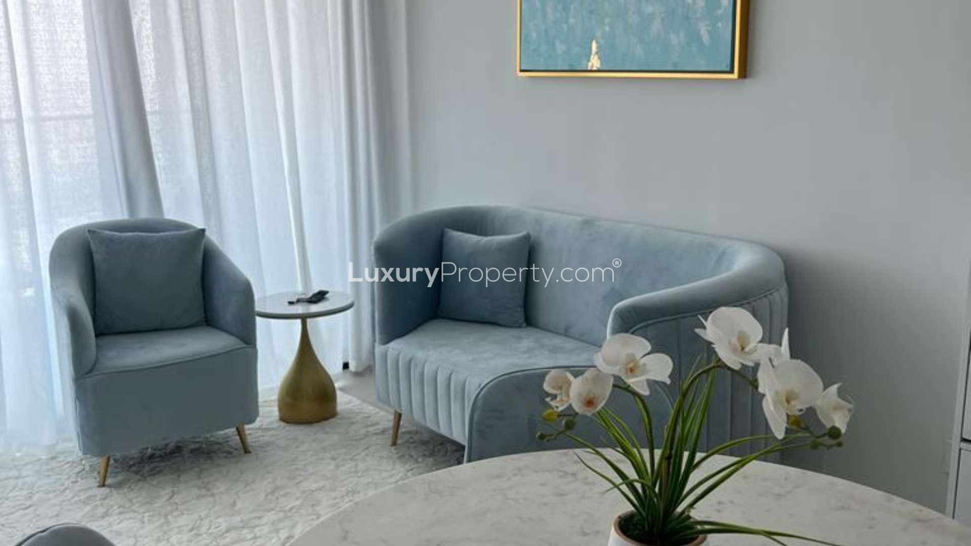 Furnished living room in Jumeirah Beach Residence apartment with elegant decor and natural light