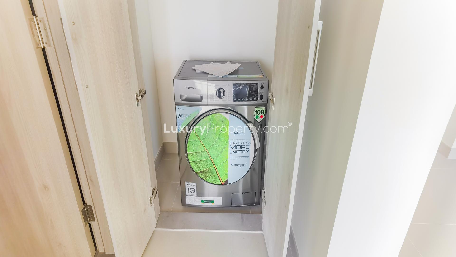 Brand-new apartment in Palm Jebel Ali with modern energy-efficient washing machine in utility area