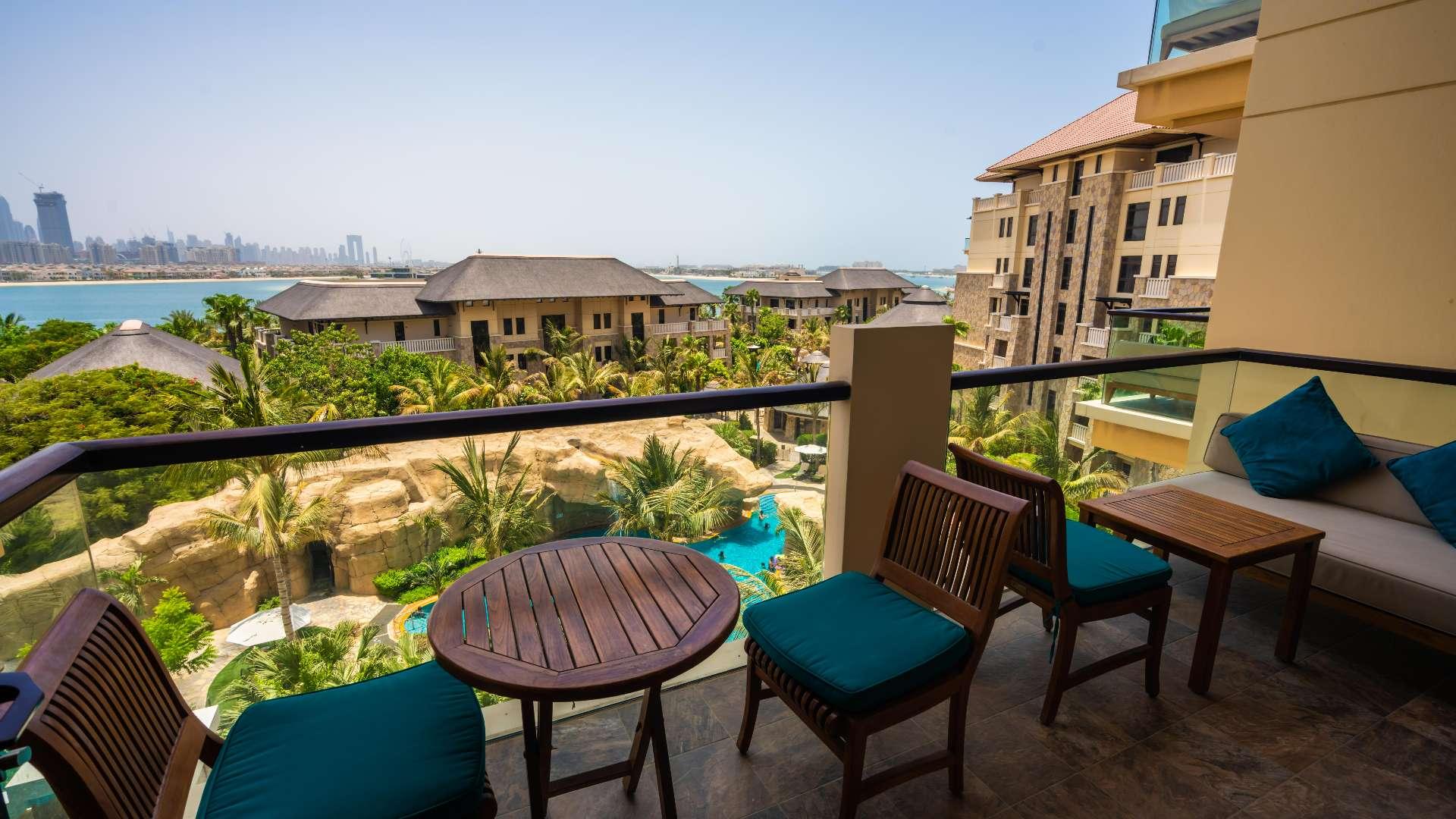 Luxurious kitchen in serviced apartment at Sofitel, Palm Jumeirah, featuring modern wooden cabinetry