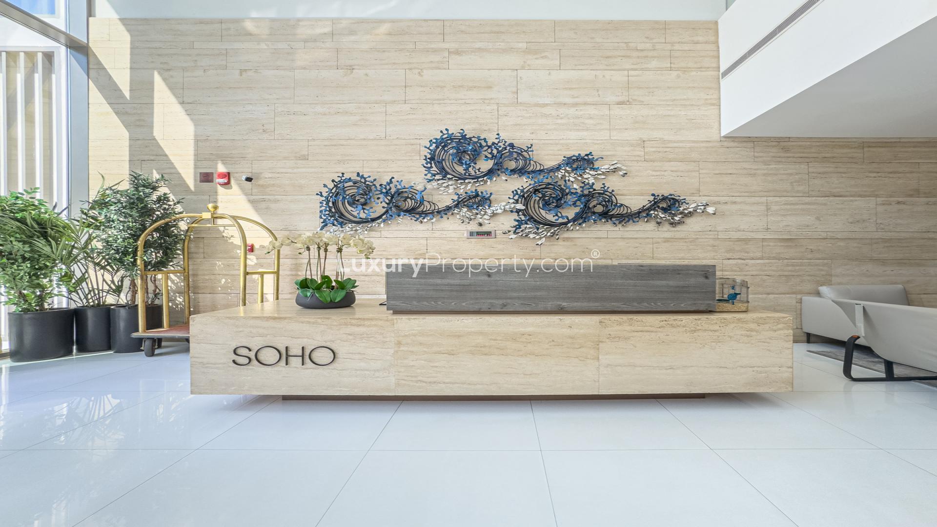 Fully furnished living room in Soho Palm Jumeirah apartment with modern decor and TV setup
