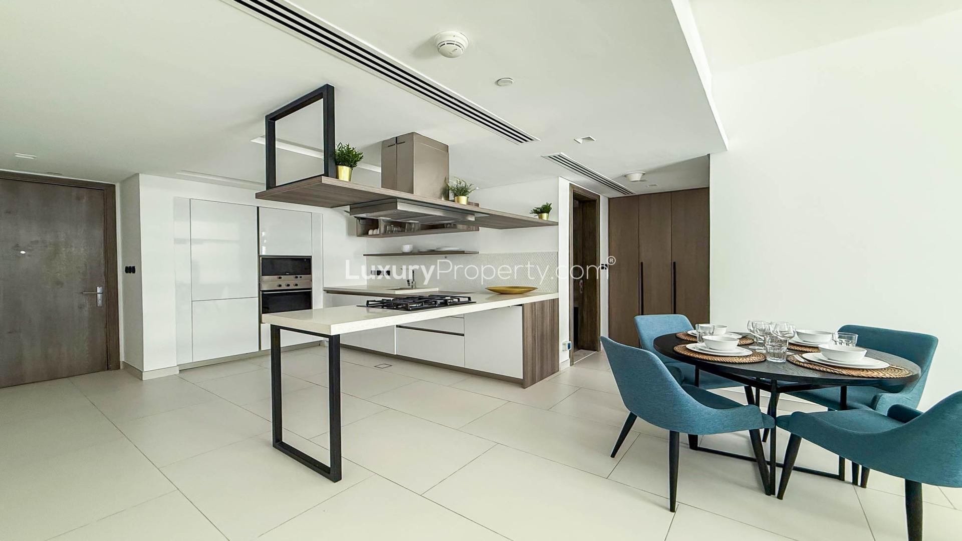 Modern living room in Soho Palm Jumeirah apartment with dining area and large windows