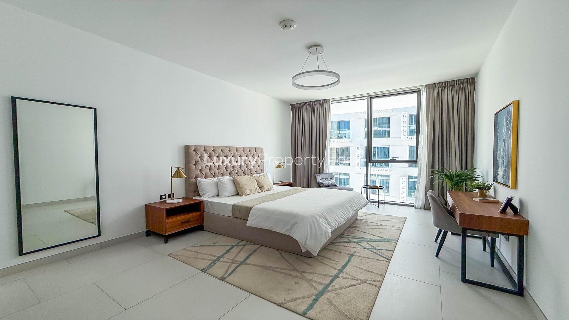 Modern living room in Soho Palm Jumeirah apartment with stylish decor and open kitchen