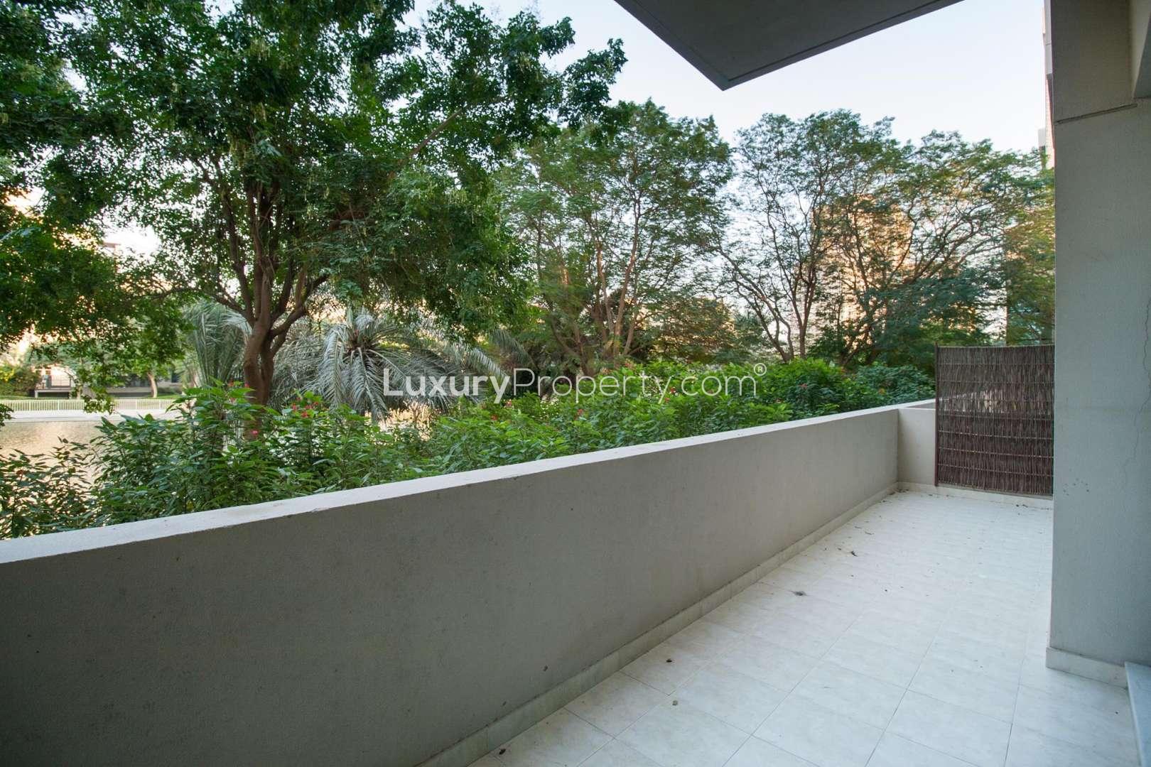 "Bright living room with large windows in 1-bedroom apartment, The Links East Tower.",Spacious balcony with lush greenery view in 1-bedroom apartment, The Links Canal, The Views