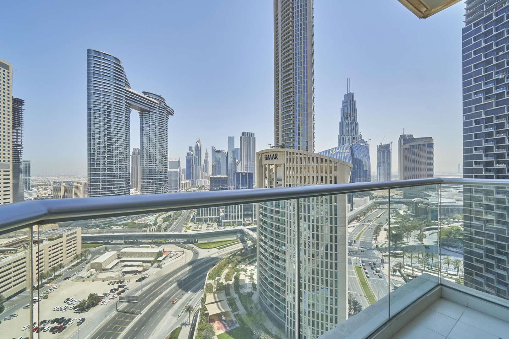 Empty apartment living room with large window view of Downtown Dubai skyline