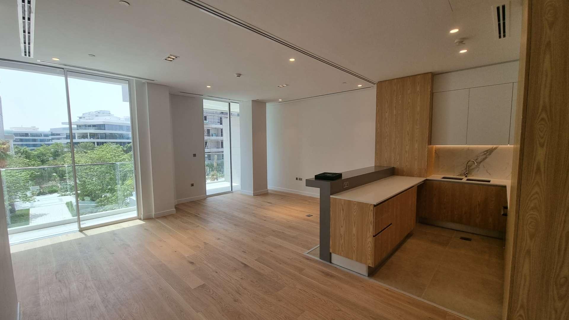 Modern kitchen with wooden cabinets in Al Barari apartment for rent, The Neighbourhood