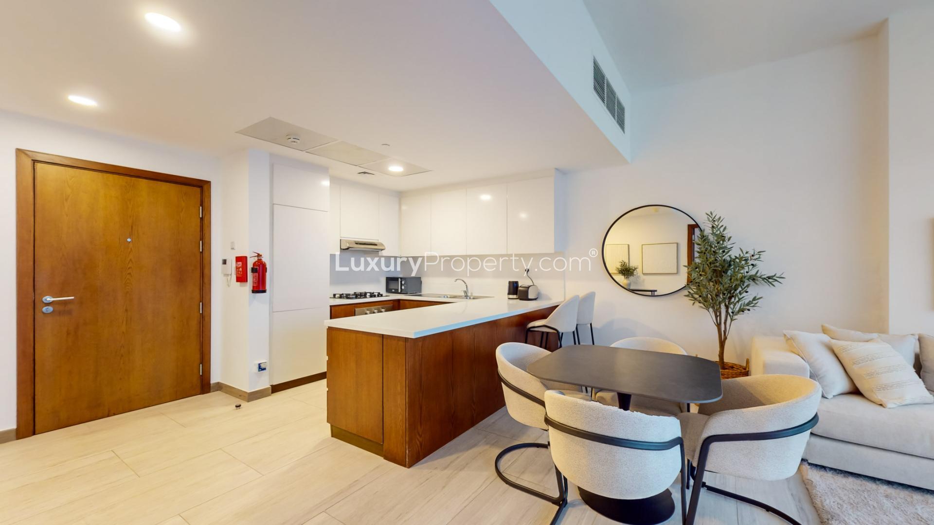 Furnished apartment living area with modern kitchen, Jumeirah Village Circle, Zaya Hameni