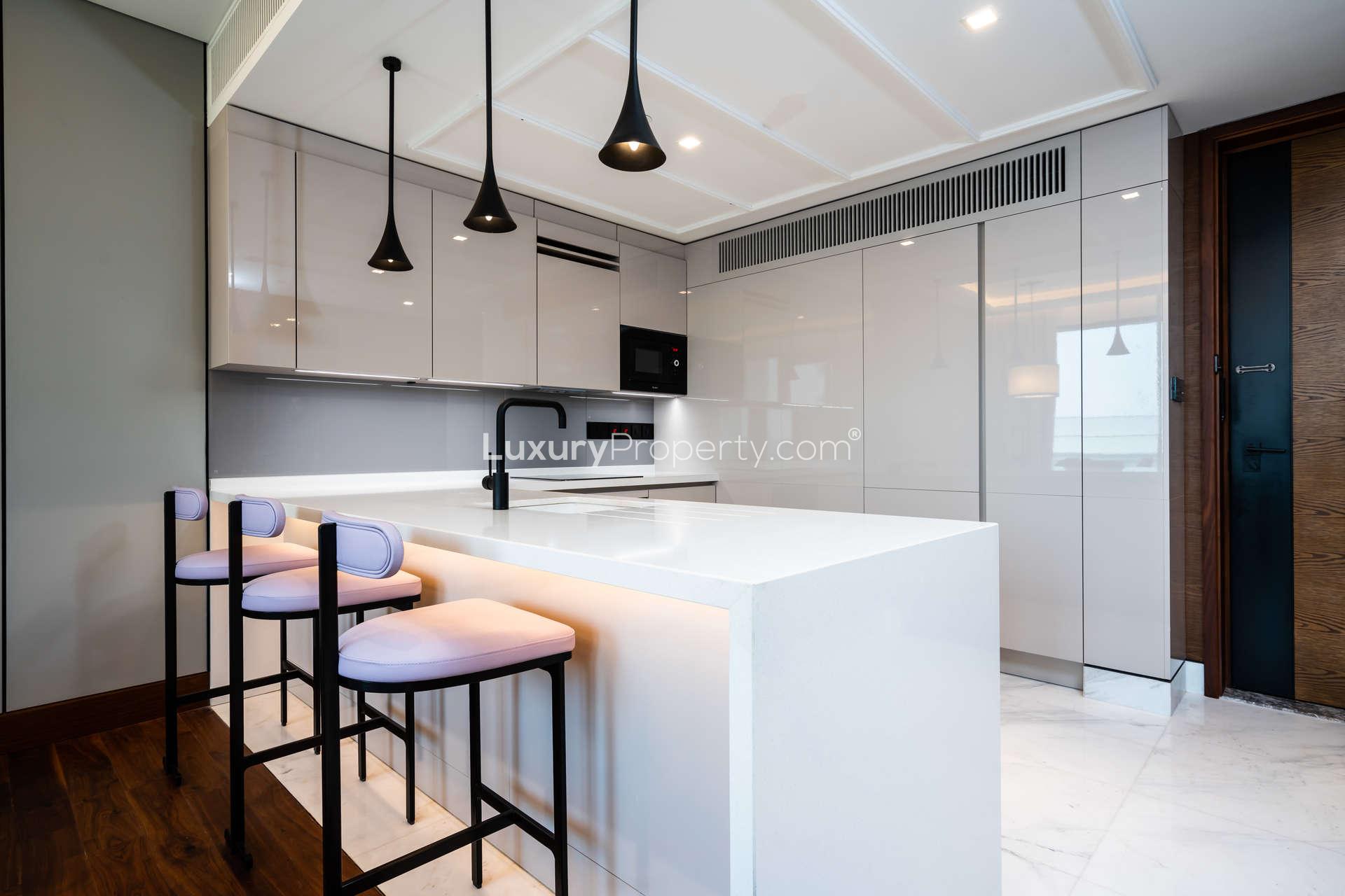 Furnished living room in Caesars Bluewaters Dubai apartment with modern decor and balcony view