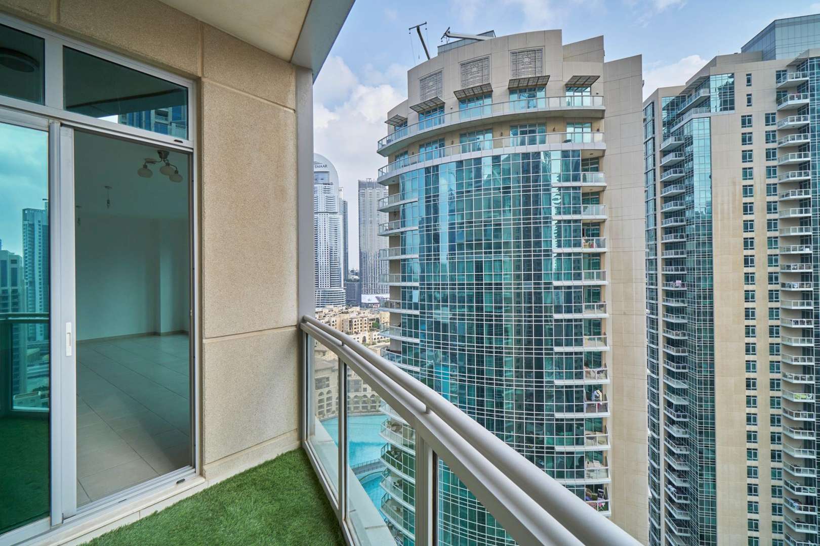 "Balcony view of Downtown Dubai skyscrapers from apartment in The Residences for rent.",Balcony view from apartment for rent in Downtown Dubai, overlooking skyscrapers and cityscape