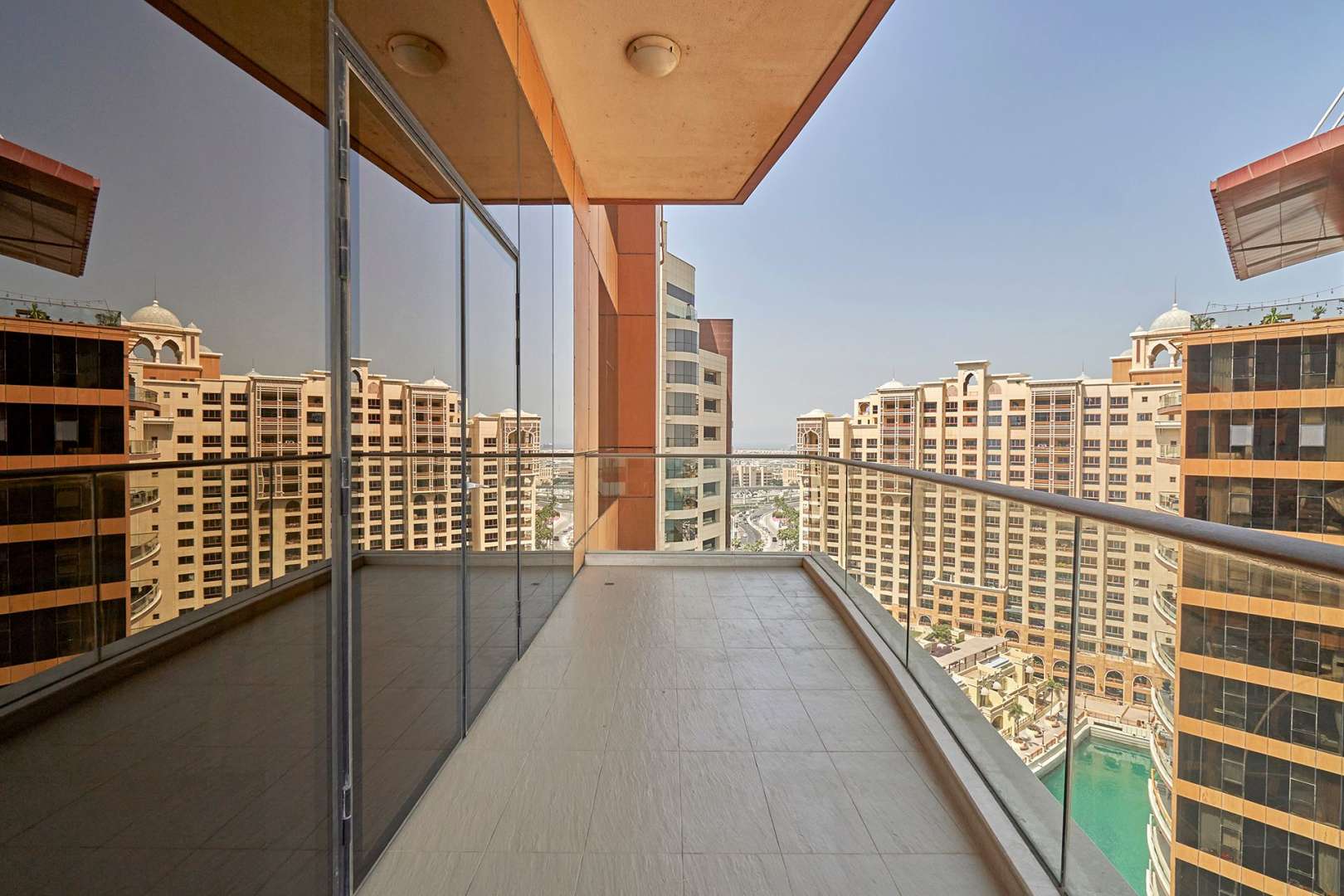 Aerial view of Tiara Residences apartment complex, pool, and Palm Jumeirah beach in Dubai