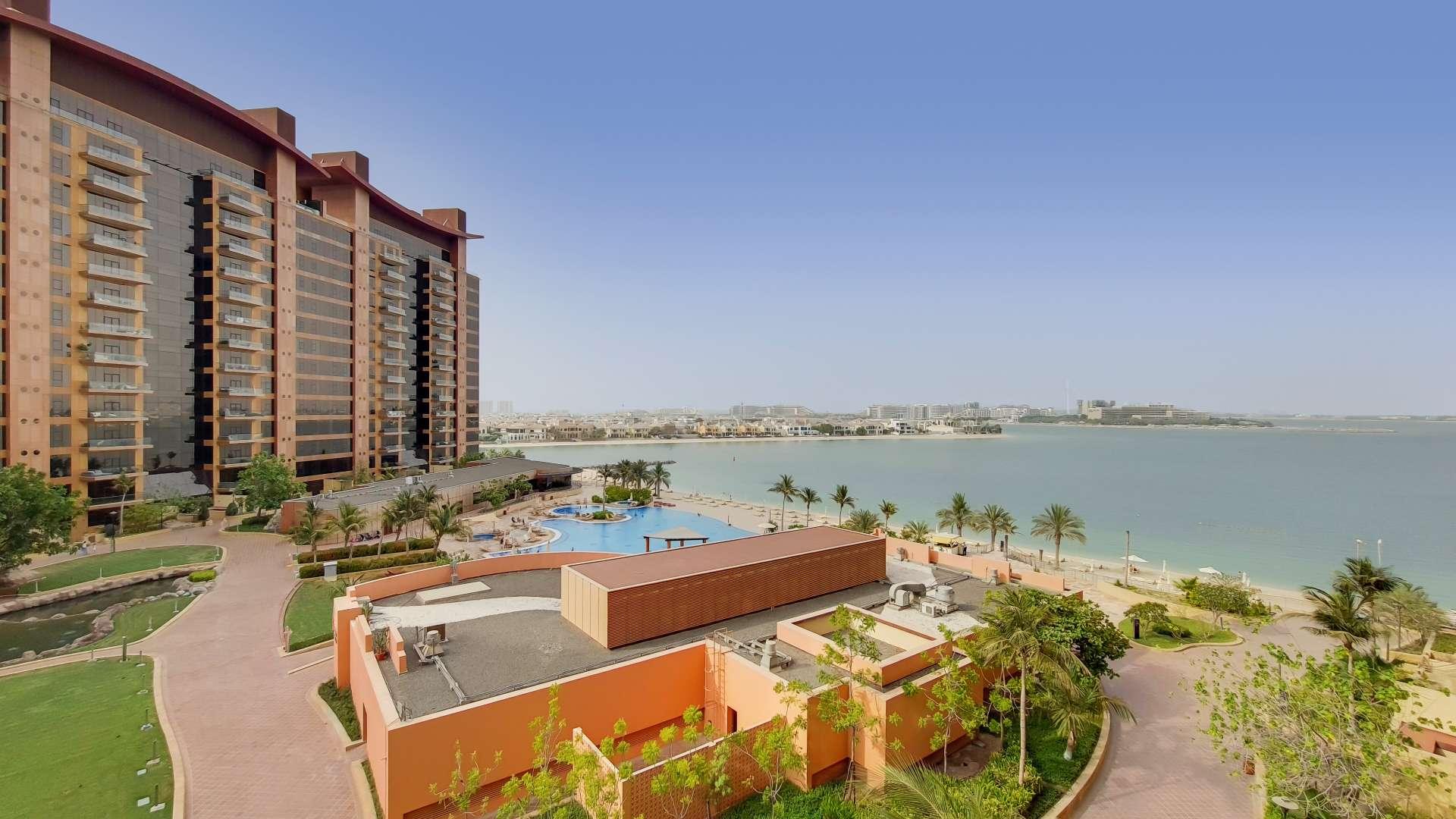 "Tiara Residences apartment balcony with sea views, Palm Jumeirah, available for rent.",Sea view from Tiara Residences apartment, Palm Jumeirah, showing pool and landscaped gardens