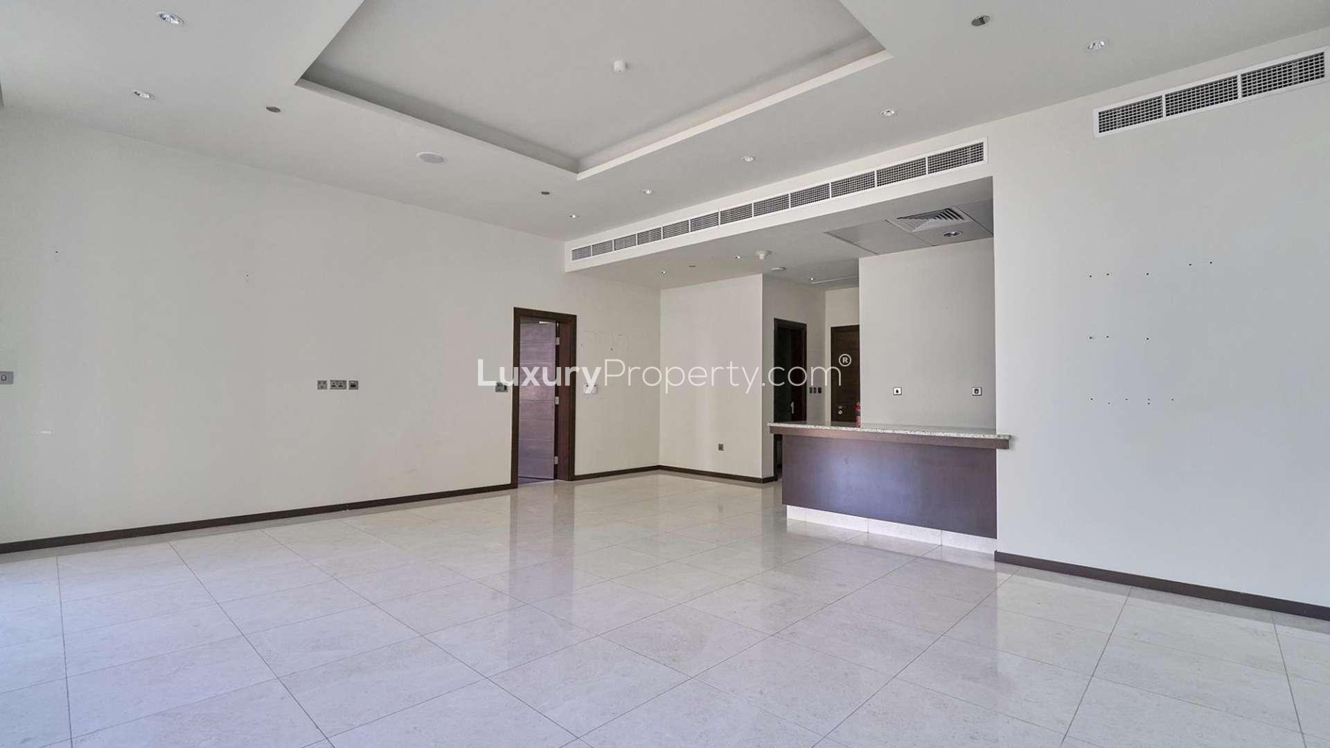 Empty living area with modern kitchen in Tiara Residence apartment, Palm Jumeirah