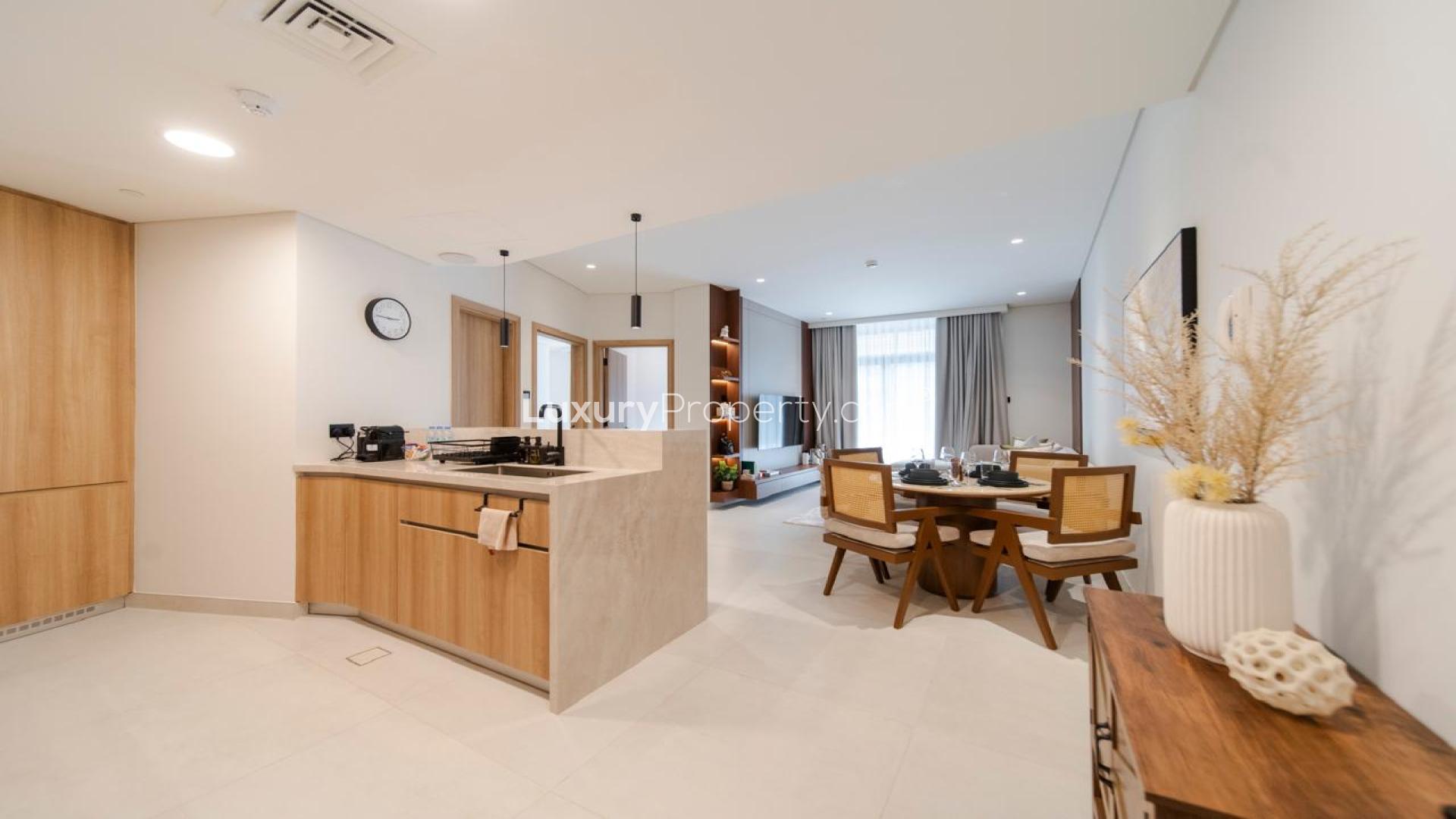Modern living room in Jumeirah Village Triangle apartment, featuring cozy seating and natural light