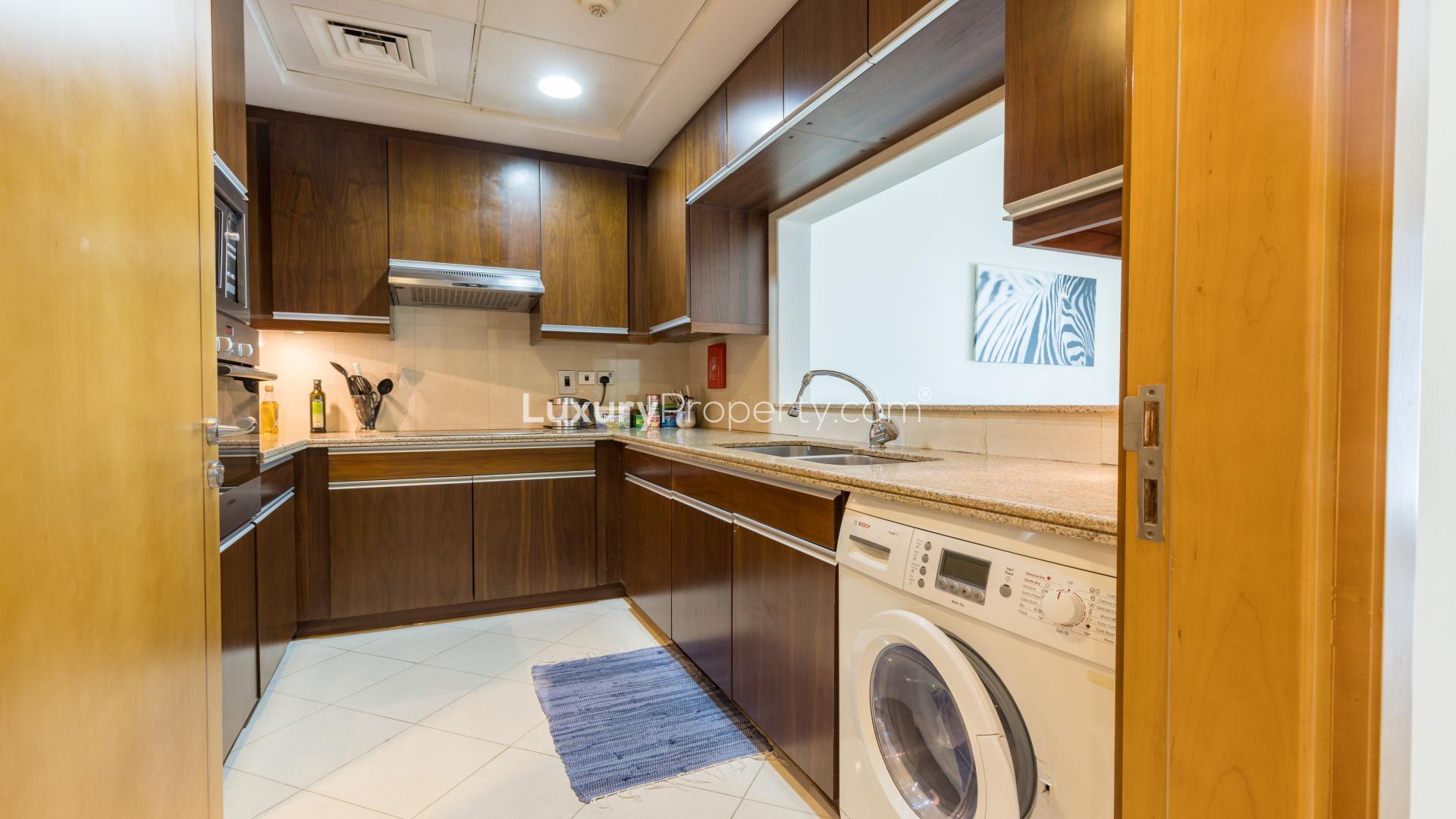 N/A,Modern kitchen in one-bedroom apartment, Trident Bayside, Dubai Marina, featuring wooden cabinets
