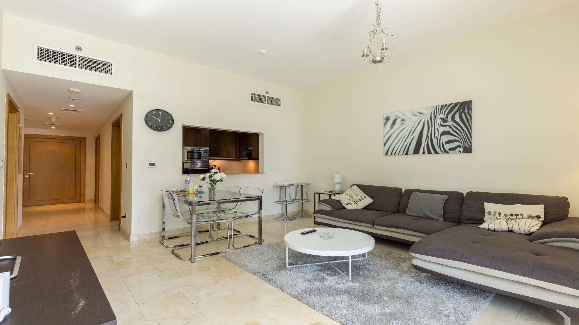 Modern living room in Trident Bayside apartment, featuring cozy sofa and stylish decor