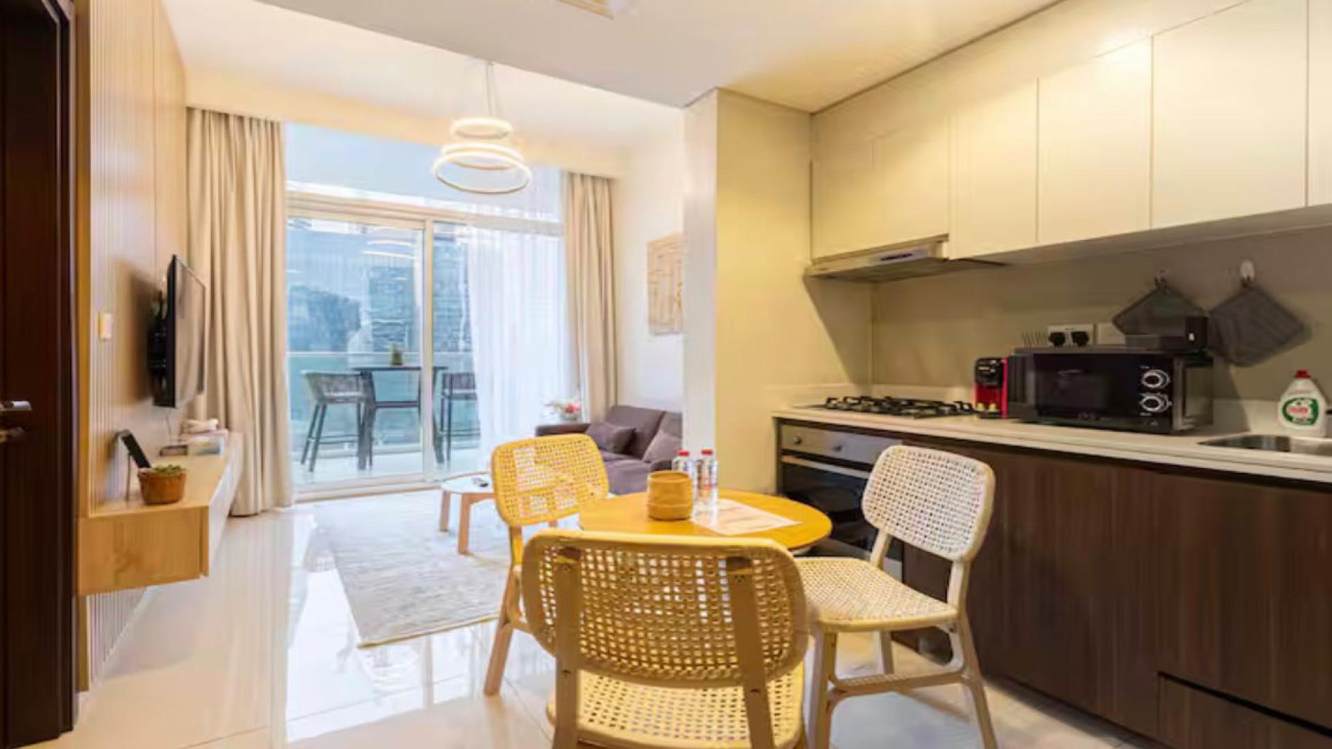 Modern living room in Vera Residences apartment, Business Bay, with city view balcony