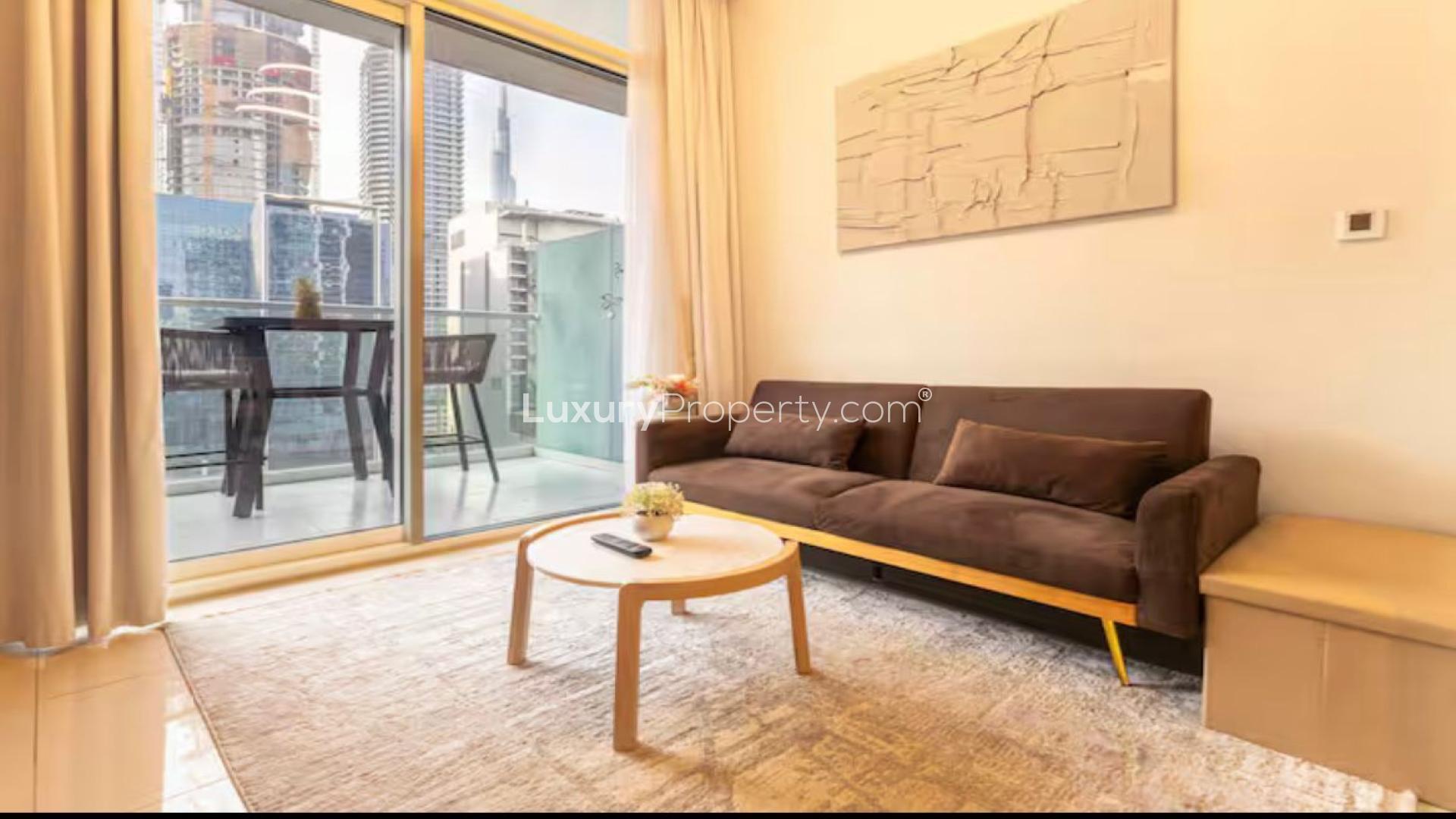 Modern living room in Vera Residences, Business Bay apartment for rent, featuring balcony view