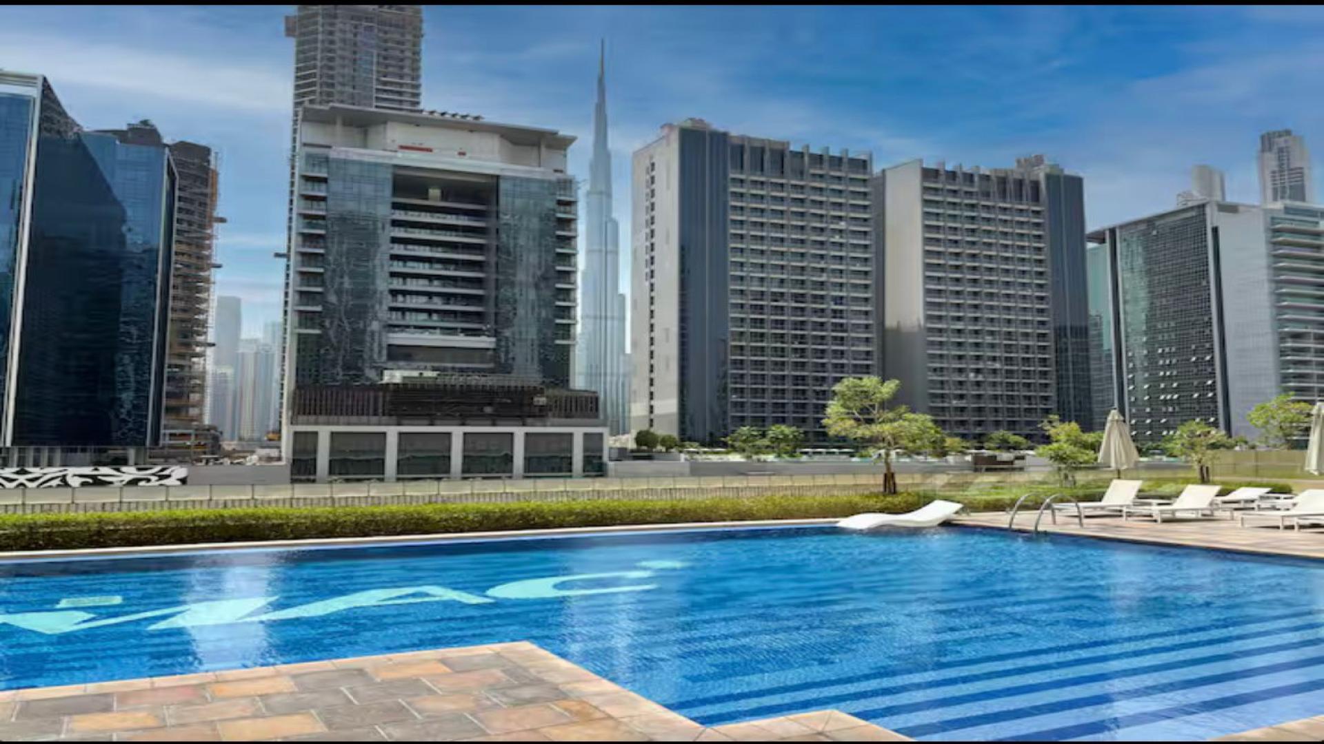 Modern living room in Vera Residences apartment, Business Bay, with city view balcony