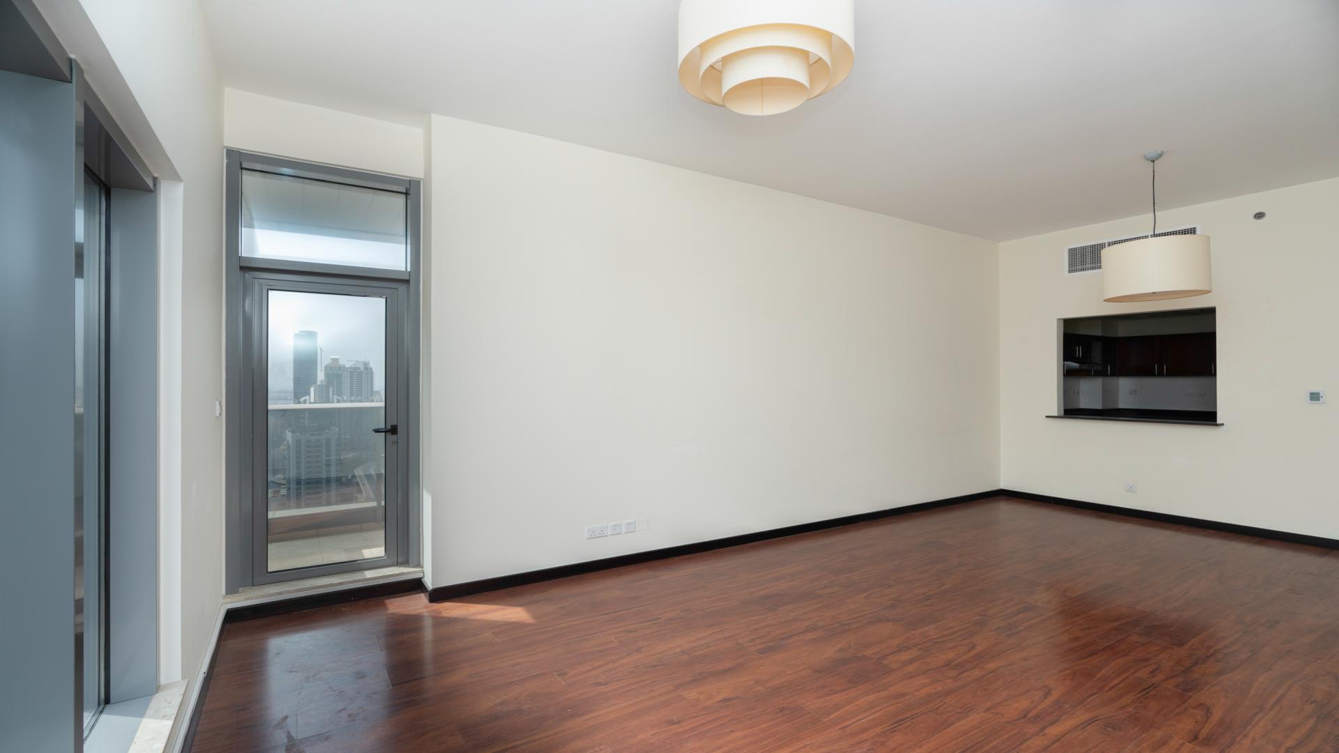 Modern living room with wooden floors and city view in Green Lake Tower 2, JLT
