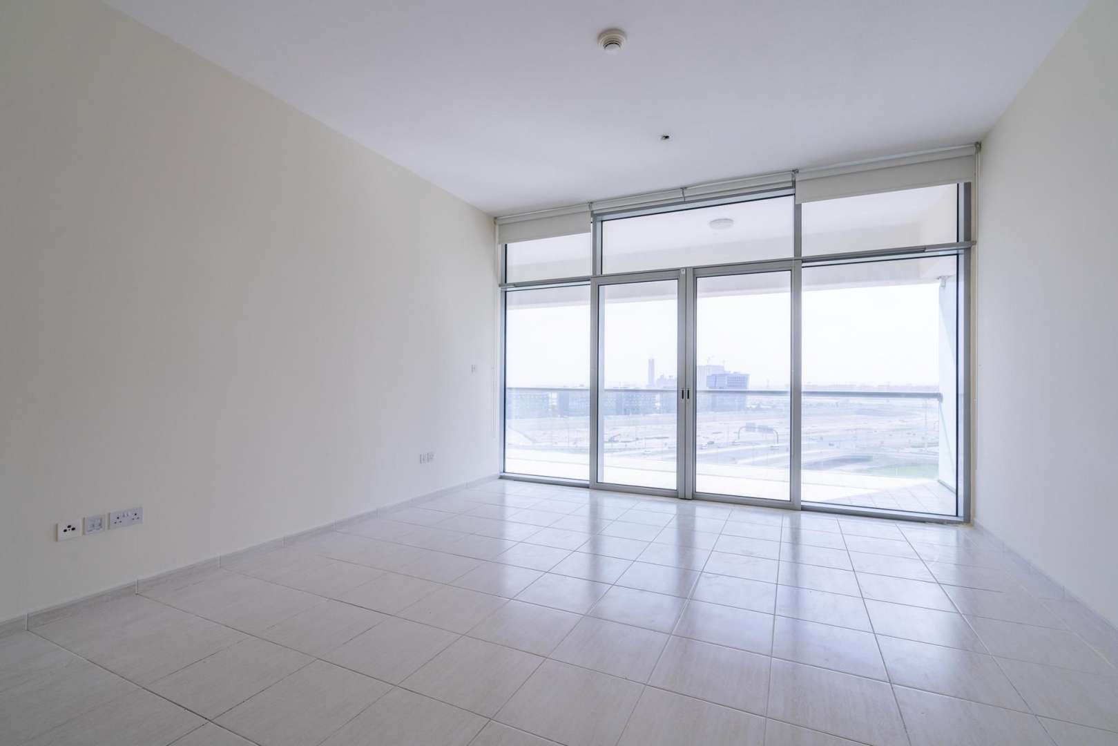 Exterior view of Windsor Manor apartment building with canal in Business Bay