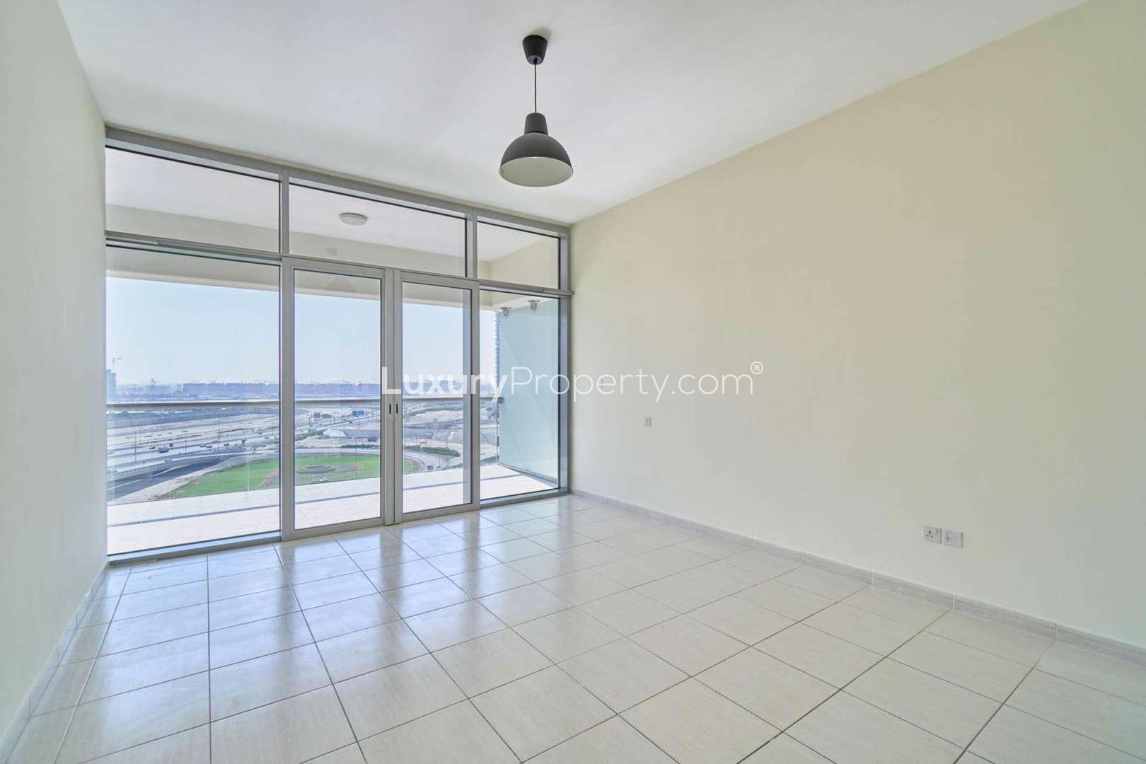 Bright living room with large windows in Windsor Manor, Business Bay apartment for rent