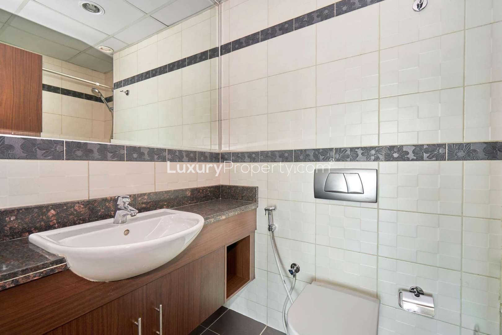 Bright living room in 1-bedroom apartment, Windsor Manor, Business Bay, featuring large windows