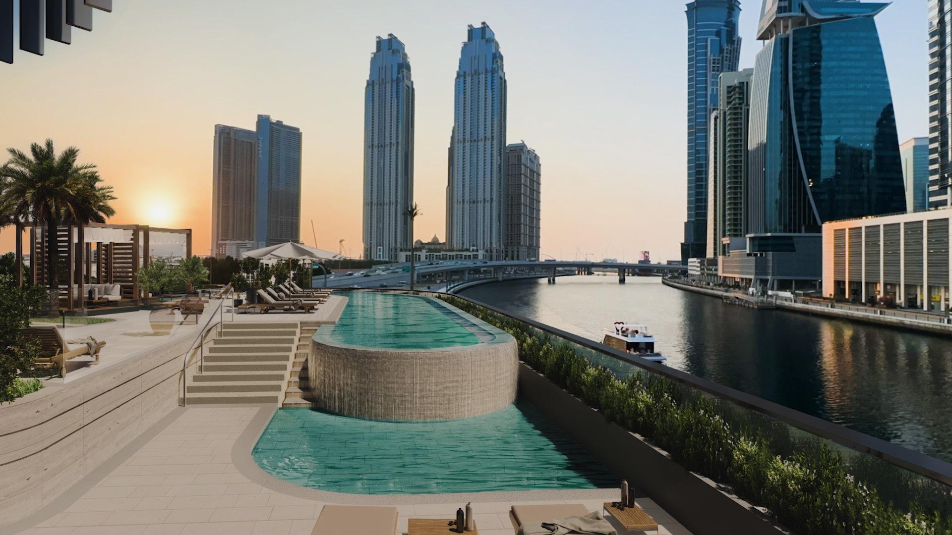 Exterior view of One River Point apartment in Business Bay, Dubai, at sunset
