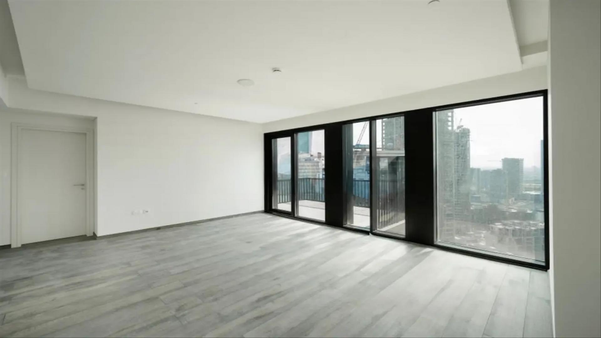 "High-floor balcony view from stylish 1-bedroom apartment in Ahad Residences, Business Bay.",High-floor apartment with large windows and city view in Ahad Residences, Business Bay