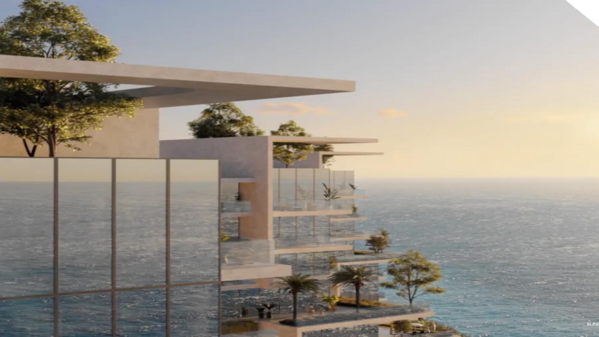 Luxurious waterfront apartment with infinity pool, palm trees, and ocean view on Al Marjan Island