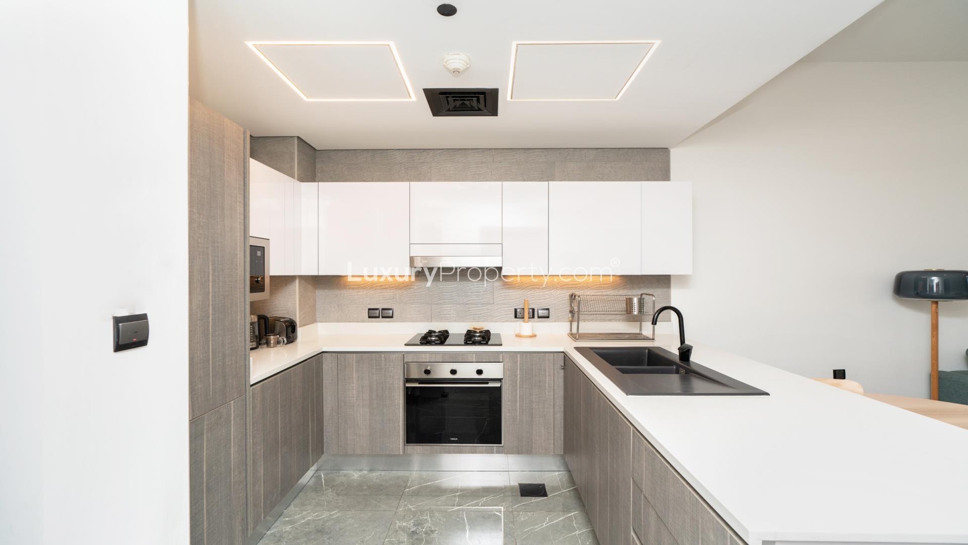 Modern living room in Joya Blanca Residences, Arjan apartment, featuring sleek kitchen and furniture