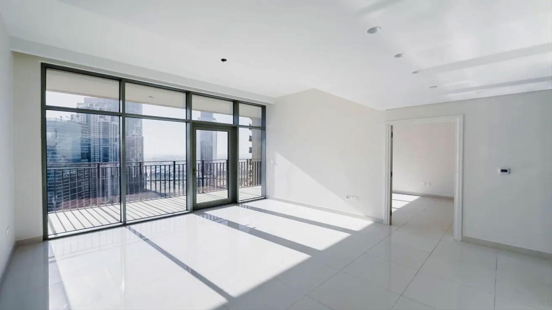 Bright living area with floor-to-ceiling windows in 1-bedroom apartment, BLVD Crescent, Downtown Dubai