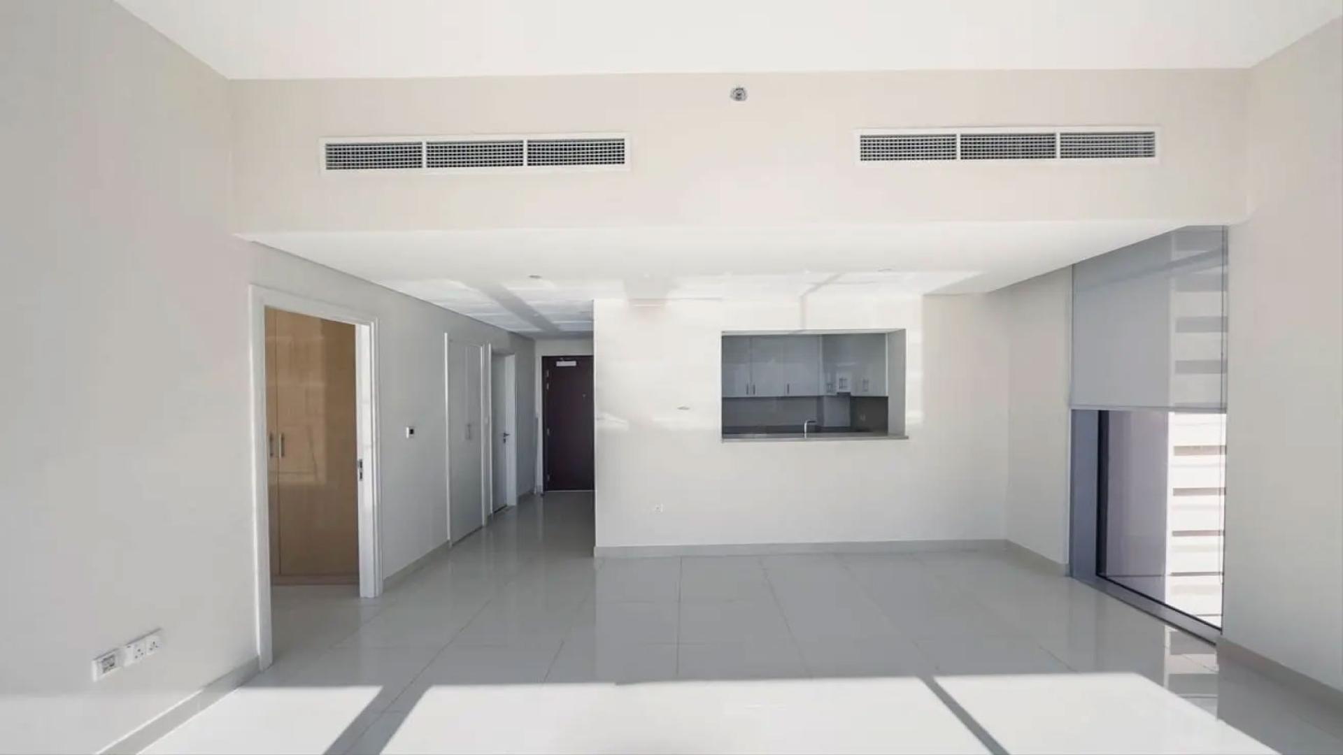 Modern kitchen in 1-bedroom apartment, BLVD Crescent, Downtown Dubai, featuring sleek cabinetry and appliances