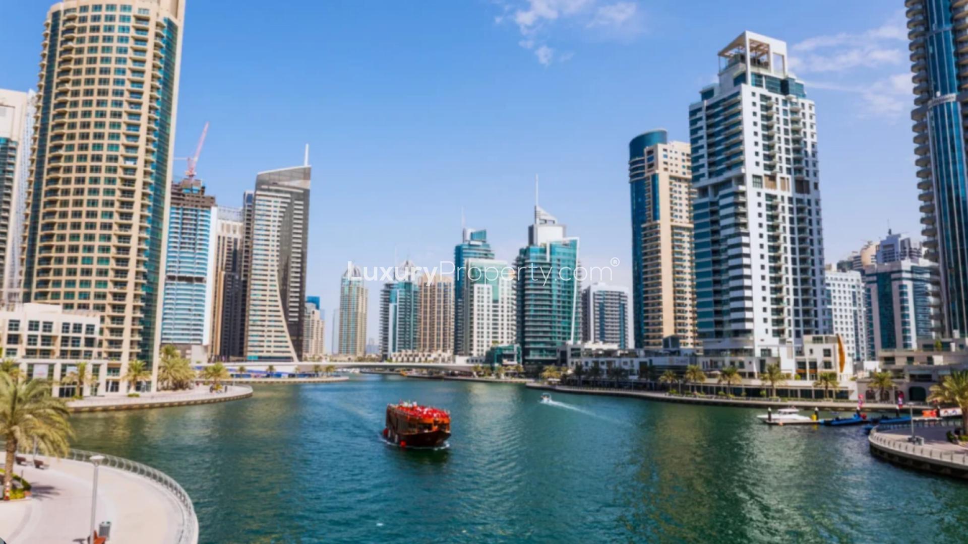 Dubai Marina view with yachts and skyscrapers near Pelagos residential apartments