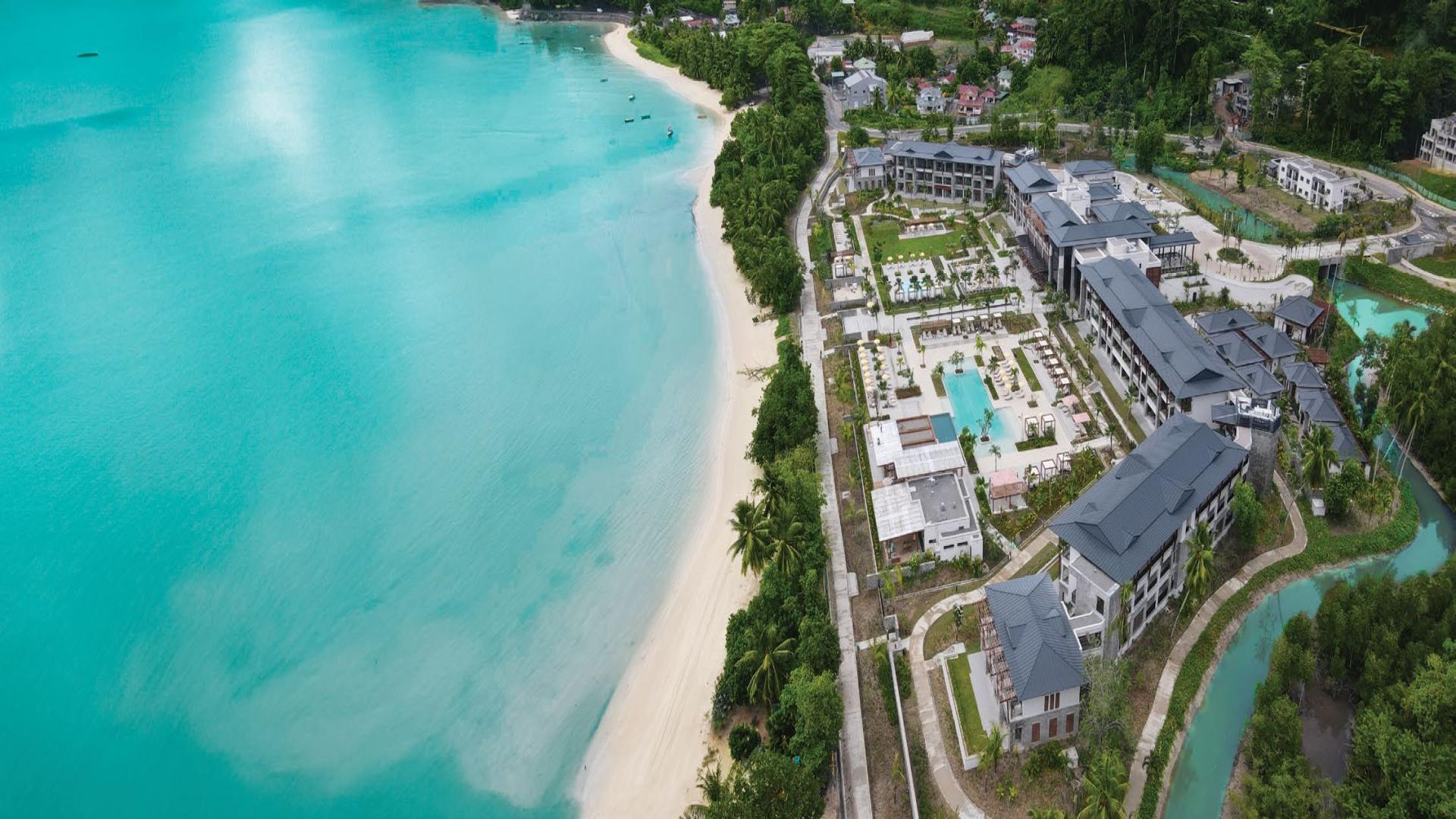 Modern apartment building with balconies and lush greenery in Albizya Bay, Mahe