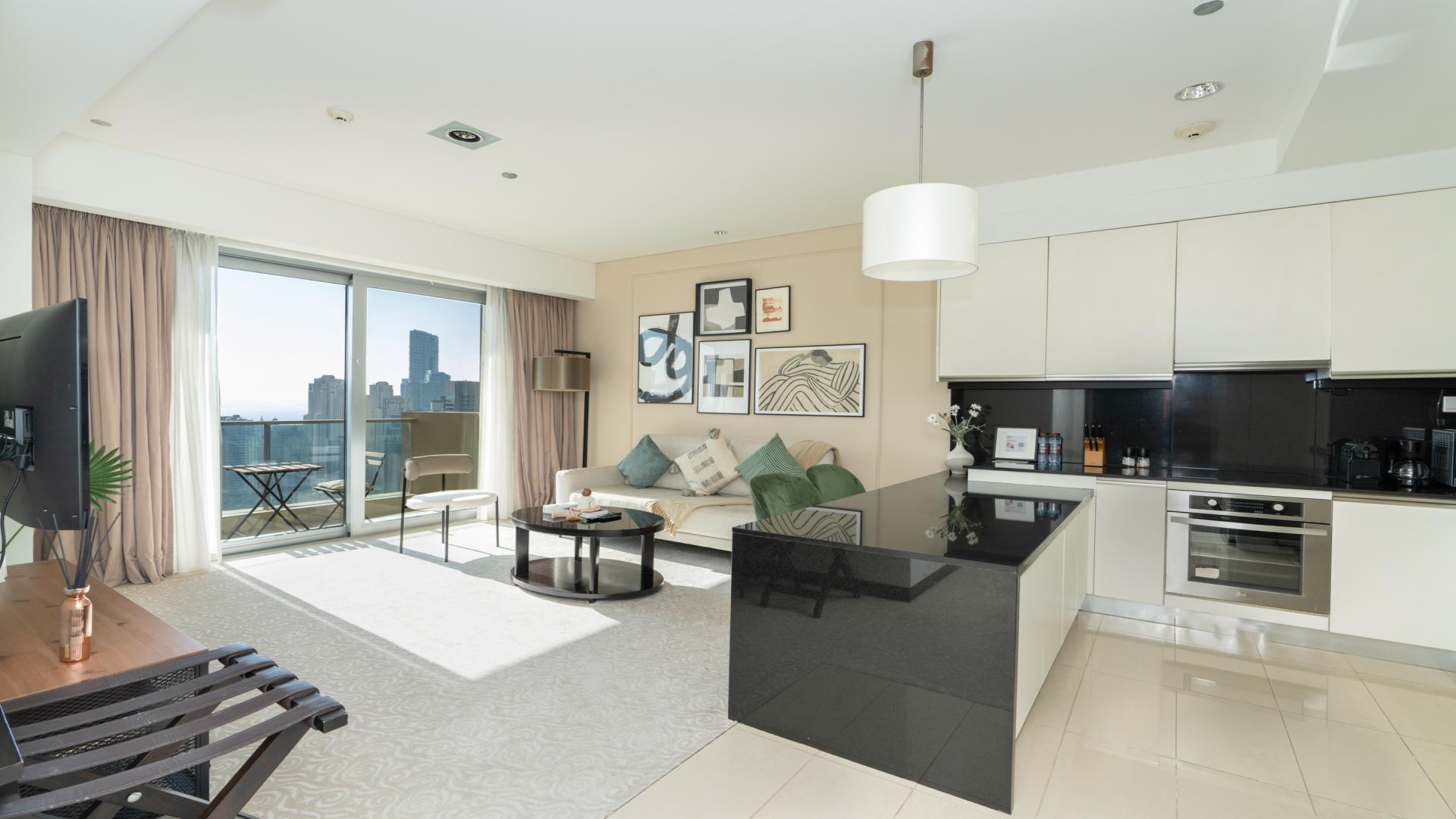 Furnished high-floor apartment living room and kitchen with modern decor, Dubai Marina views