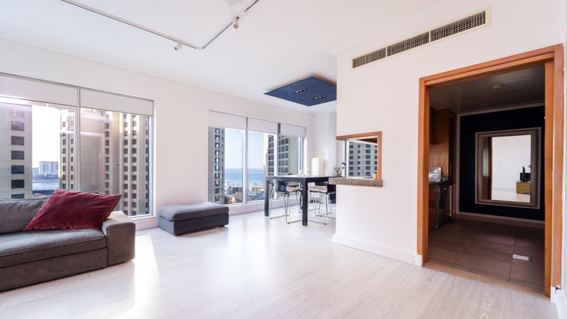 Modern living room in Shemara Tower, Dubai Marina apartment for sale, with city views