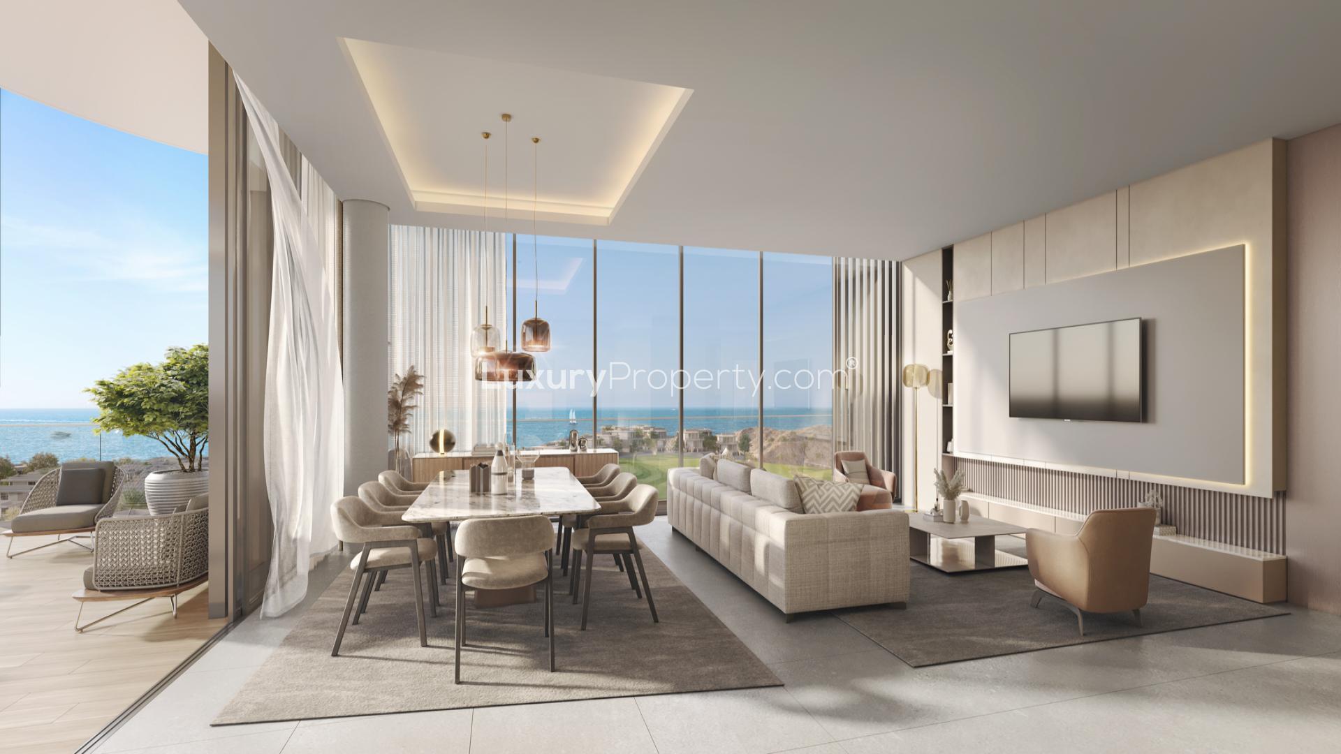 "Luxury apartment with sea view, poolside at The Great Escape 2, Muscat.","Modern apartment living room with sea and golf views, The Great Escape 2, Muscat.",Modern apartment interior with sea and golf views in Muscat's The Great Escape 2