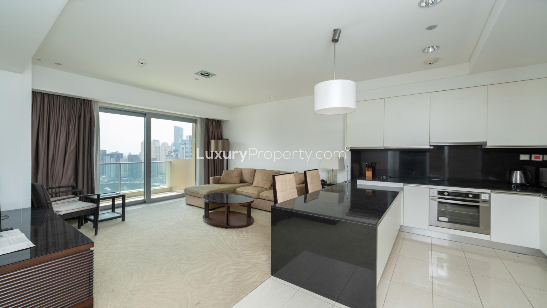 Furnished apartment interior in JW Marriott Dubai Marina with modern kitchen and cozy living area