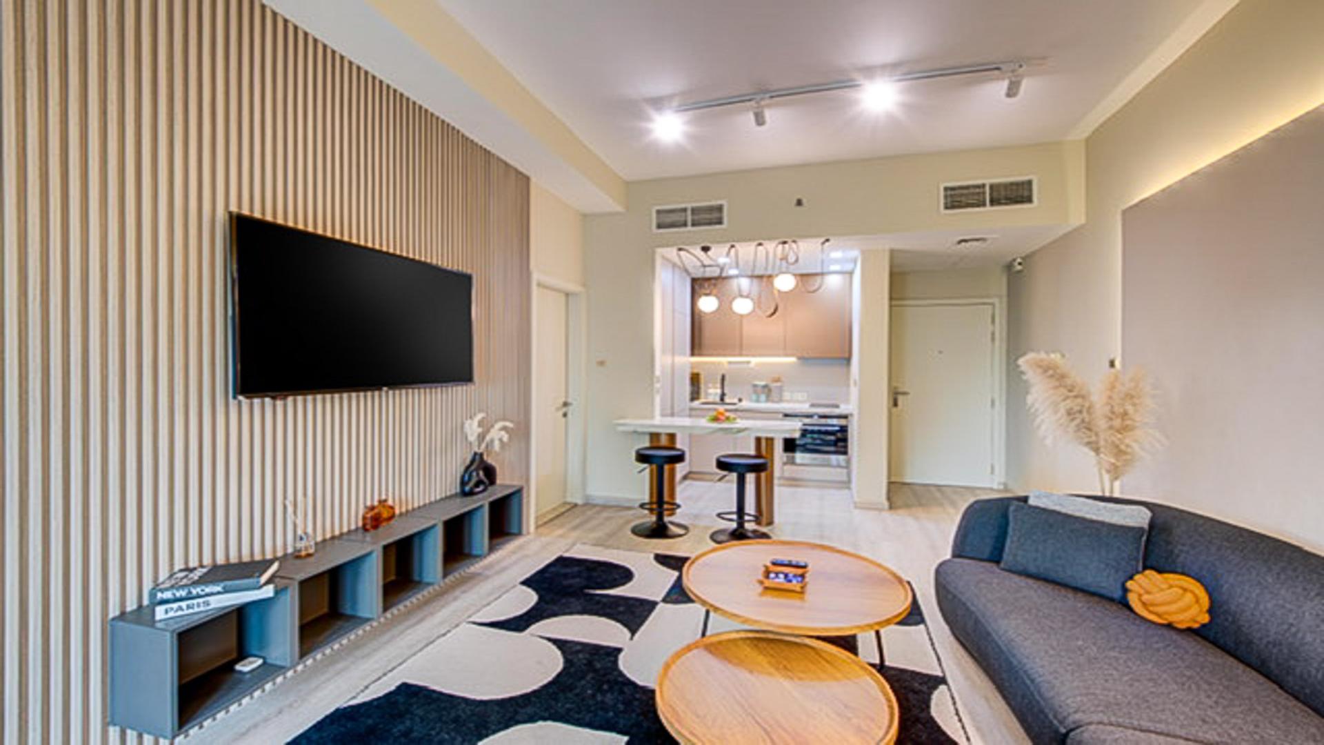 Stylish living room in renovated JLT apartment with modern decor and natural light