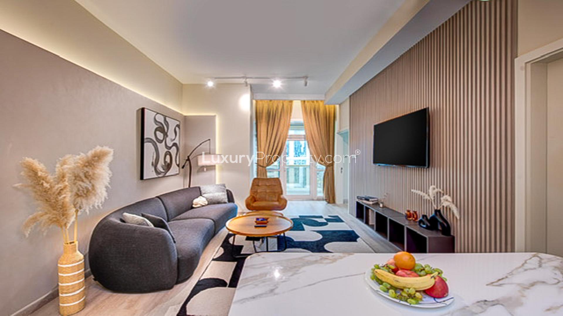 Renovated JLT apartment living room with modern decor, open kitchen, and stylish furnishings