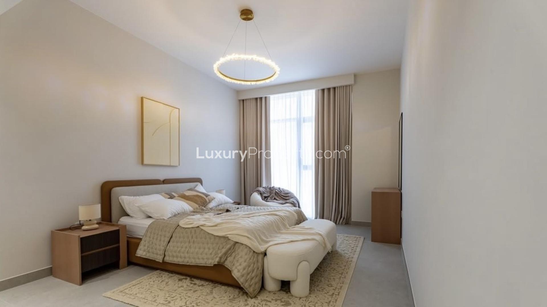 Modern kitchen in high-floor Neva Residences apartment, Jumeirah Village Circle, with stylish backsplash