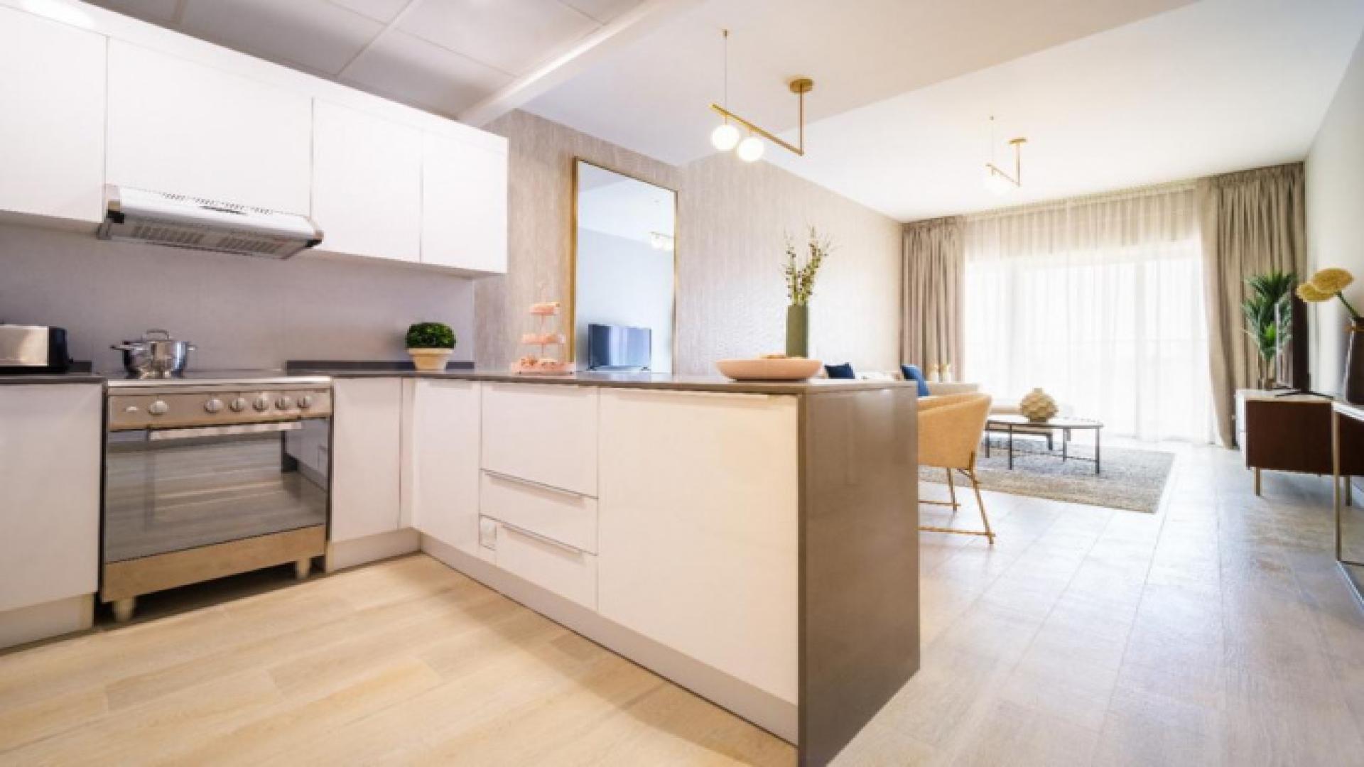 Modern living room and kitchen in Bloom Towers apartment, JVC Dubai, for sale