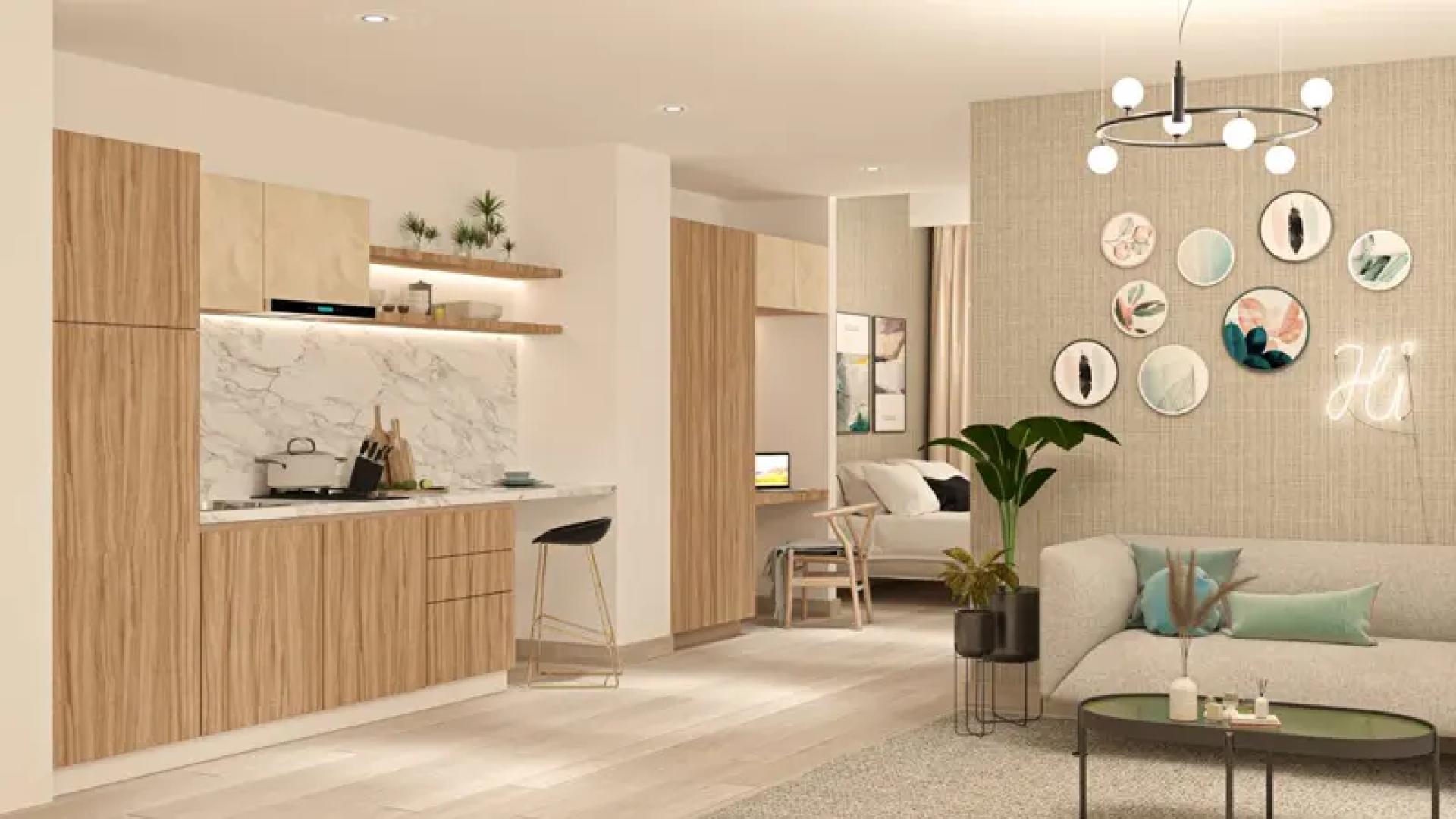 Outdoor pool and basketball court at Aura by Grovy Apartments in JVC, Dubai