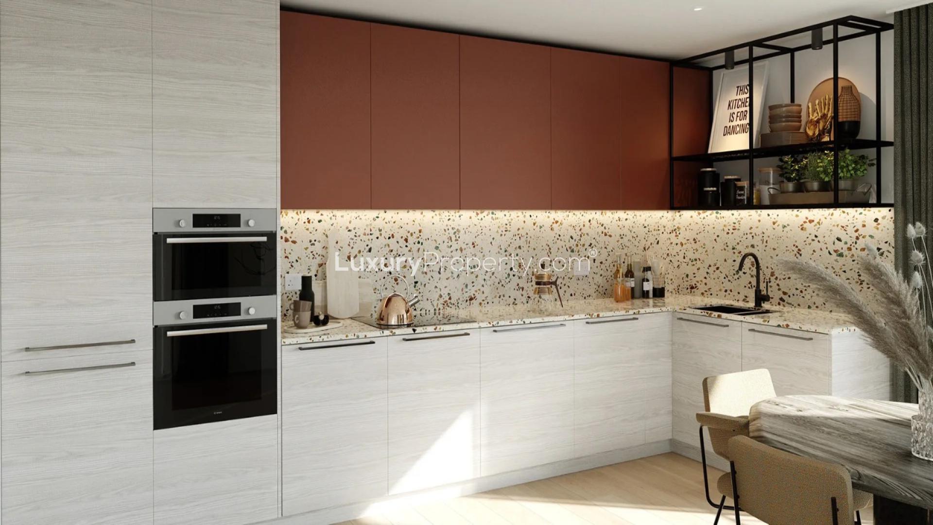 Modern kitchen and dining area in Heron Wharf apartment, London. Elegant interior design